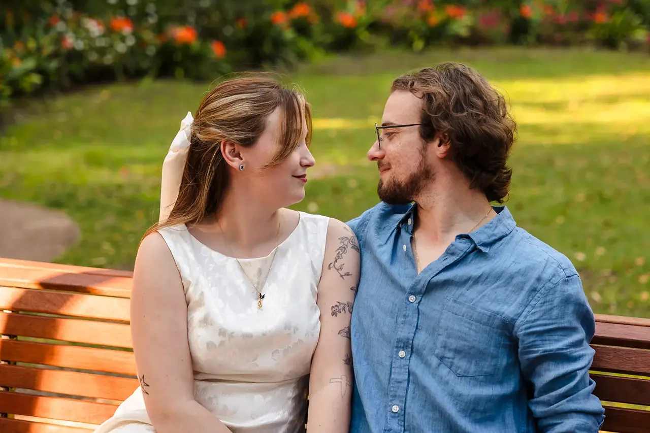 Arden and Kobi sitting close together on a garden bench at Wanneroo Botanic Gardens