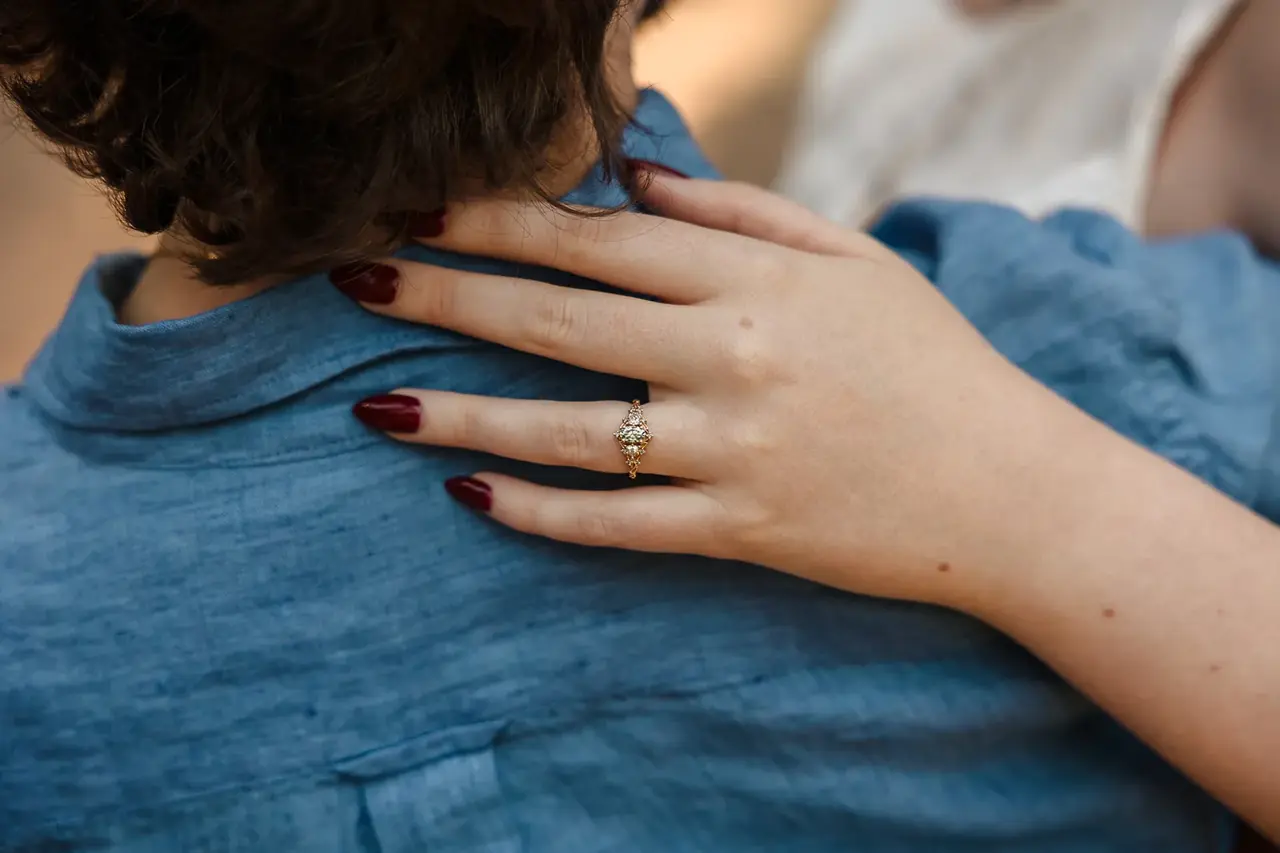 A close-up of Arden's engagement ring as she rests her hand on Kobi's shoulder at Wanneroo Botanic Gardens