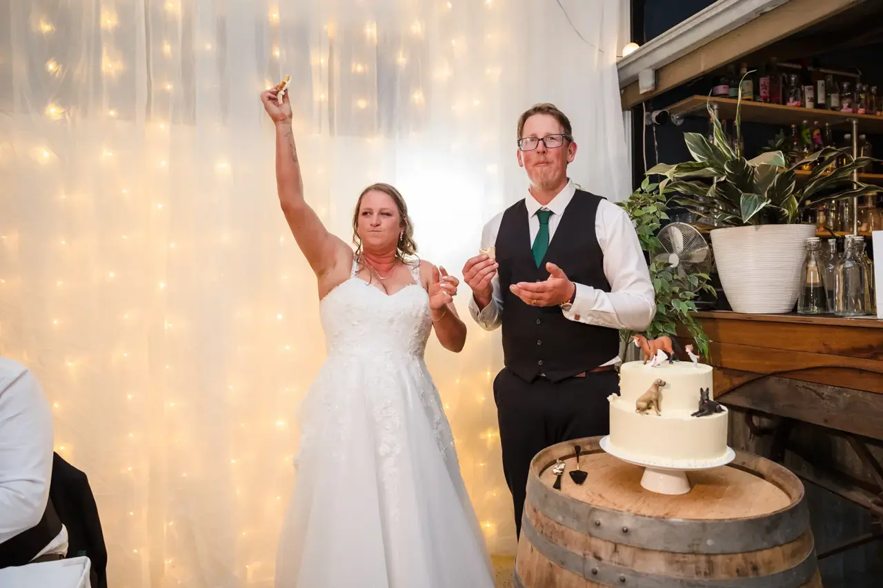 Courtney raises a fist in triumph after the cake cutting