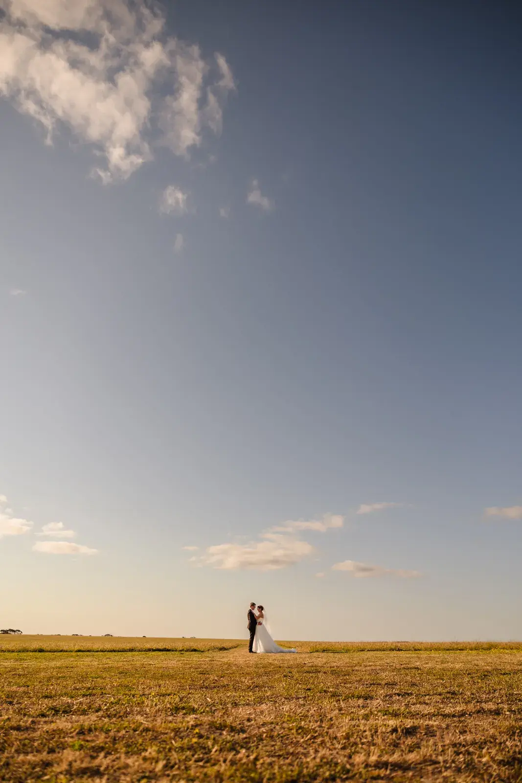 Courtney and Jason small against a huge Wheatbelt sky