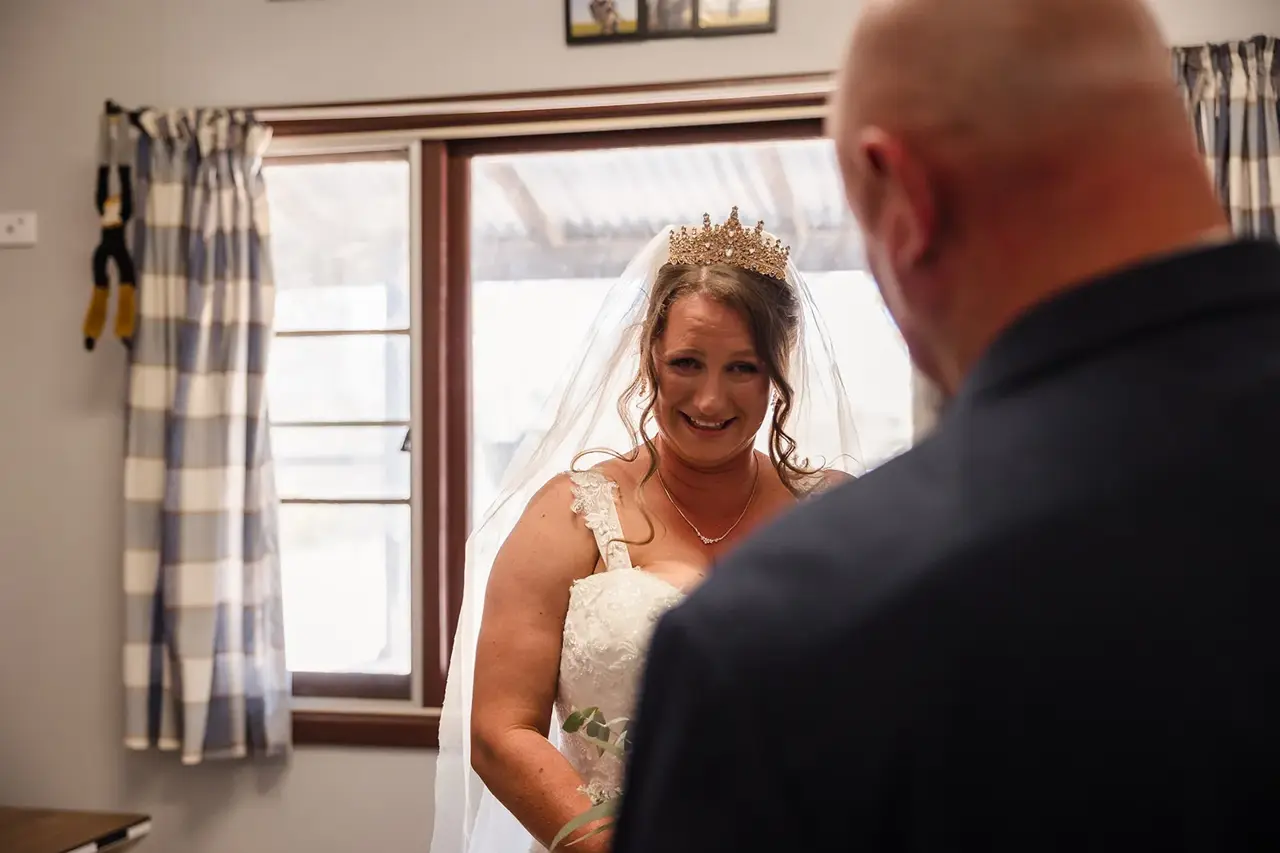 Courtney smiles at her dad as he sees her in her dress for the first time