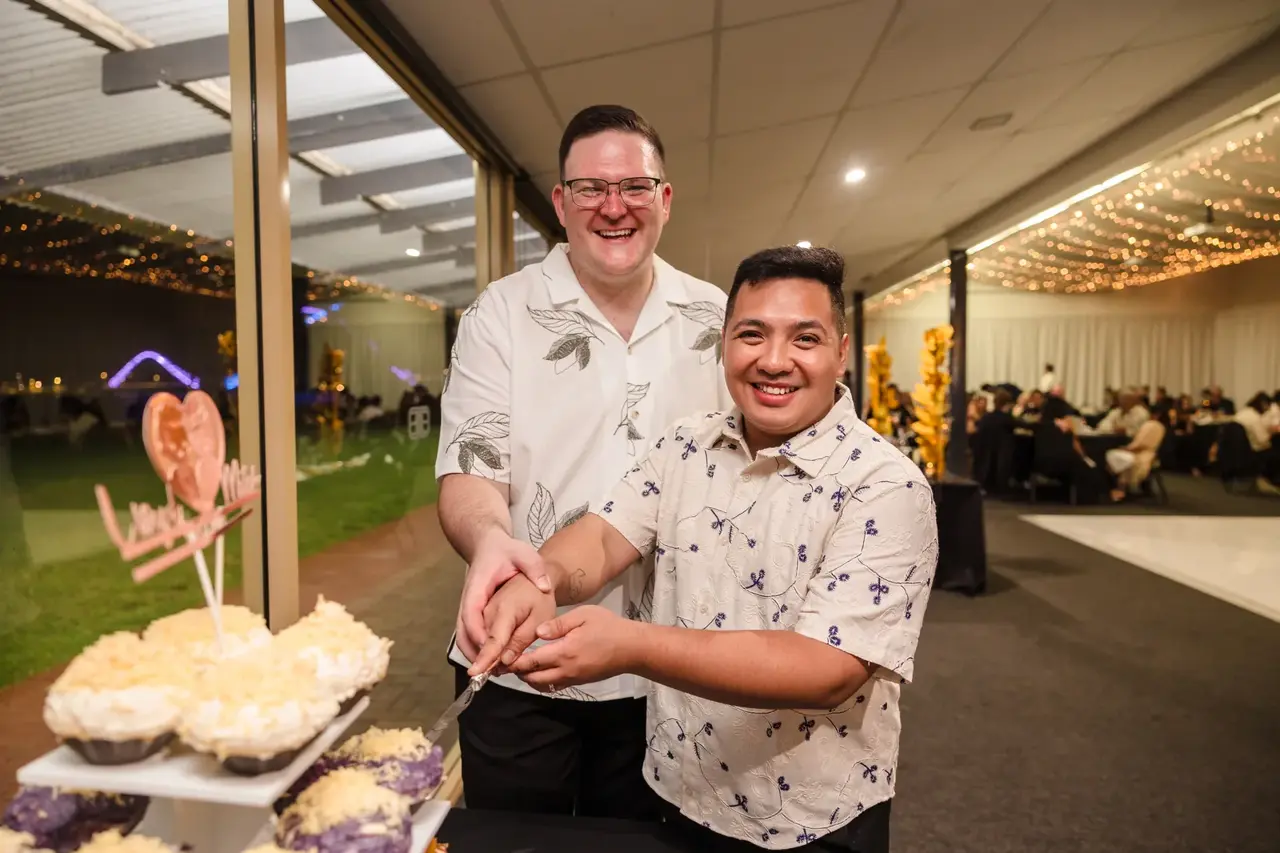 Lloyd and Mitch cutting the cake at their Burswood on Swan reception