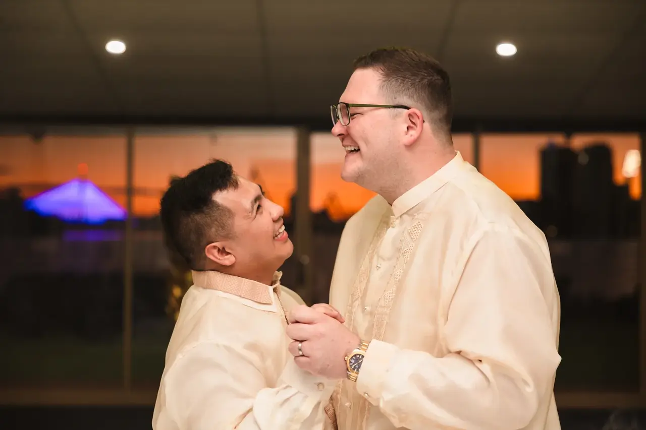 Lloyd and Mitch share their first dance with the sunset behind them at Burswood on Swan