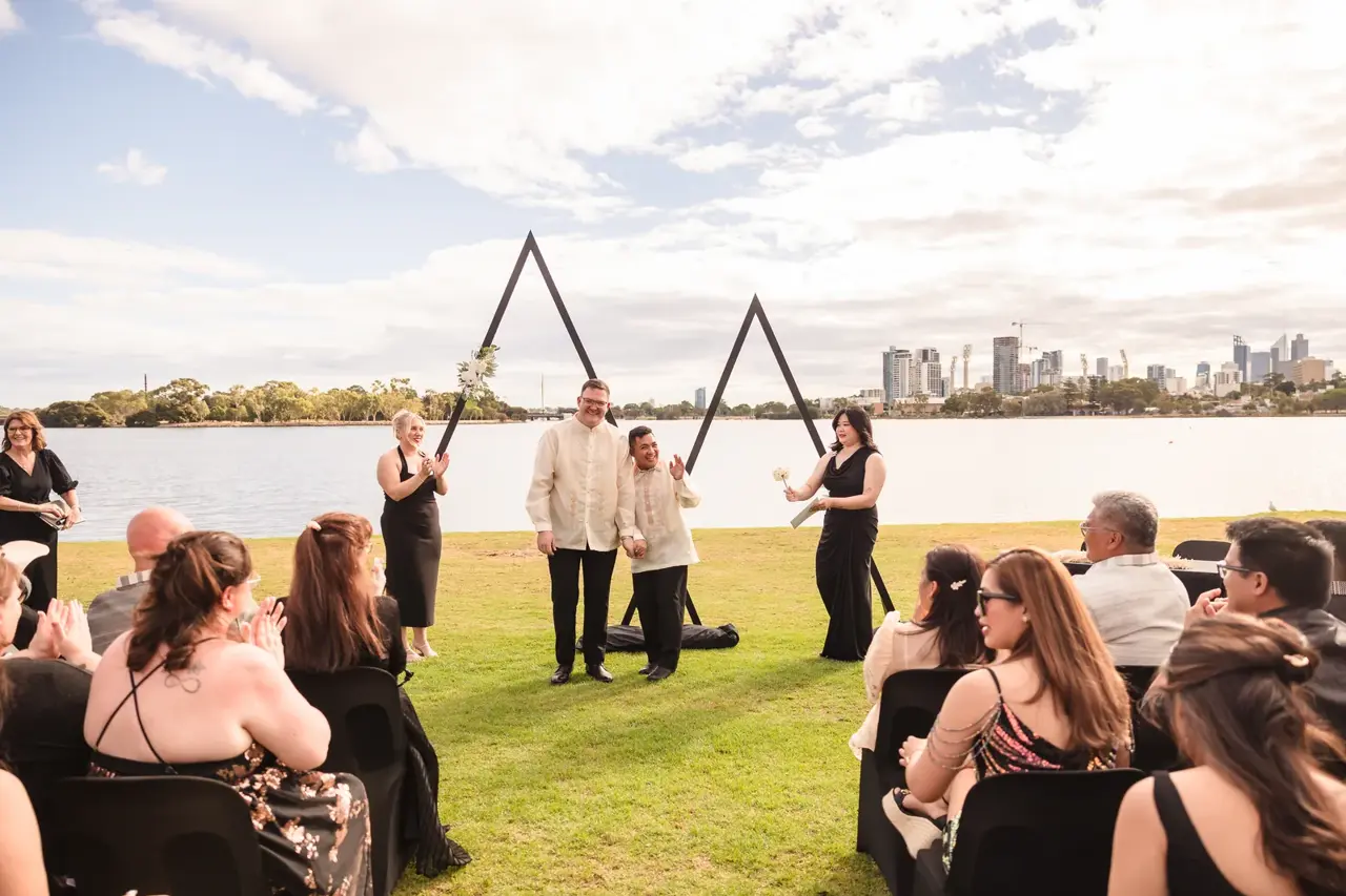 Lloyd and Mitch just married at the arbour with the Swan River and Perth skyline behind at Burswood on Swan