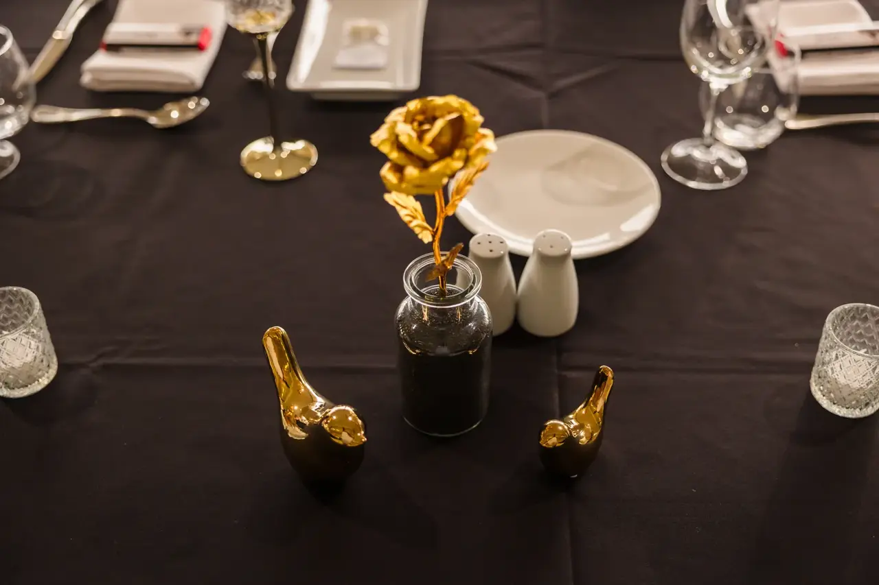 Black and gold reception table styling with a gold rose at Burswood on Swan