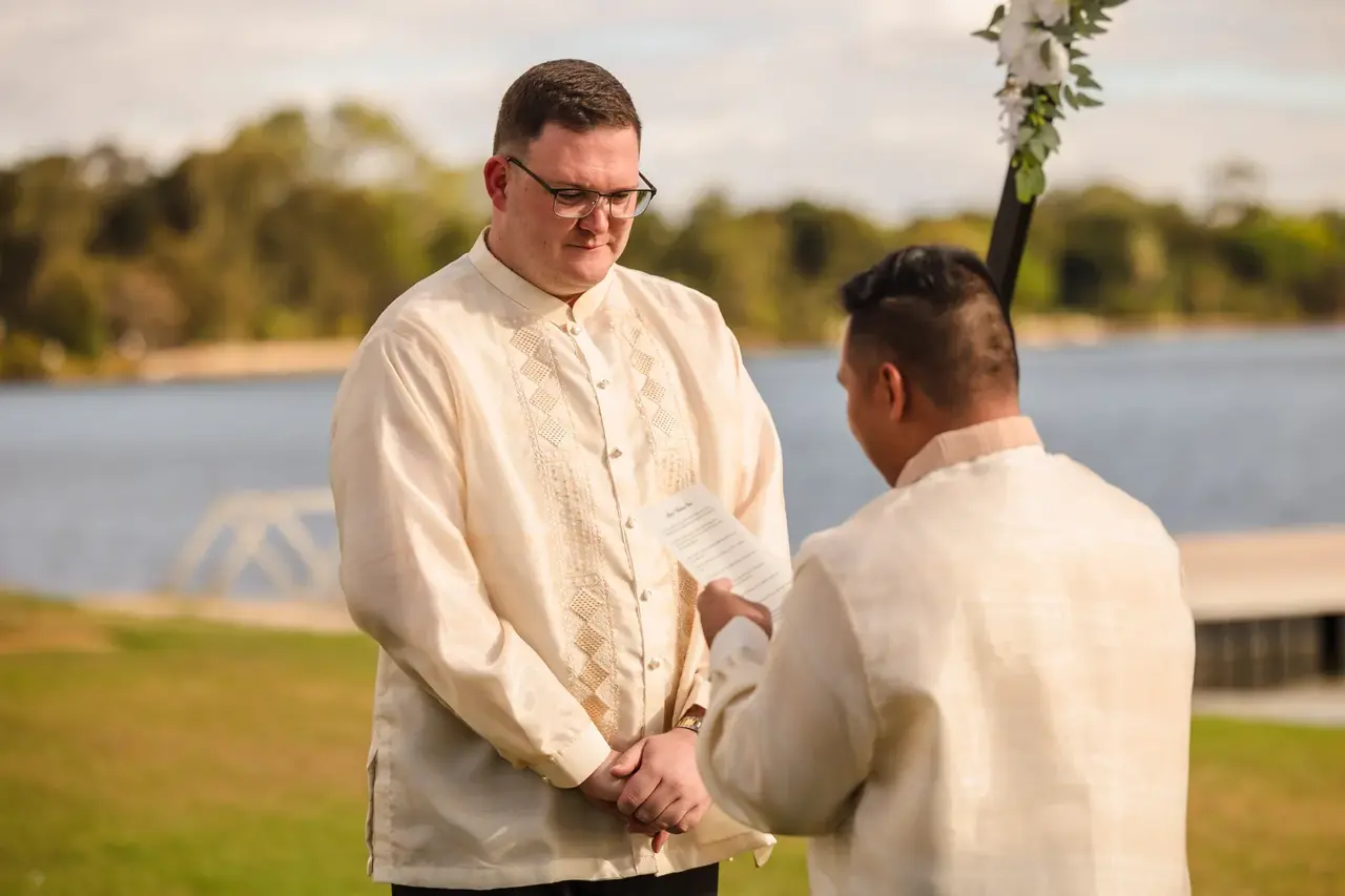 Lloyd reading his vows at the riverside ceremony at Burswood on Swan