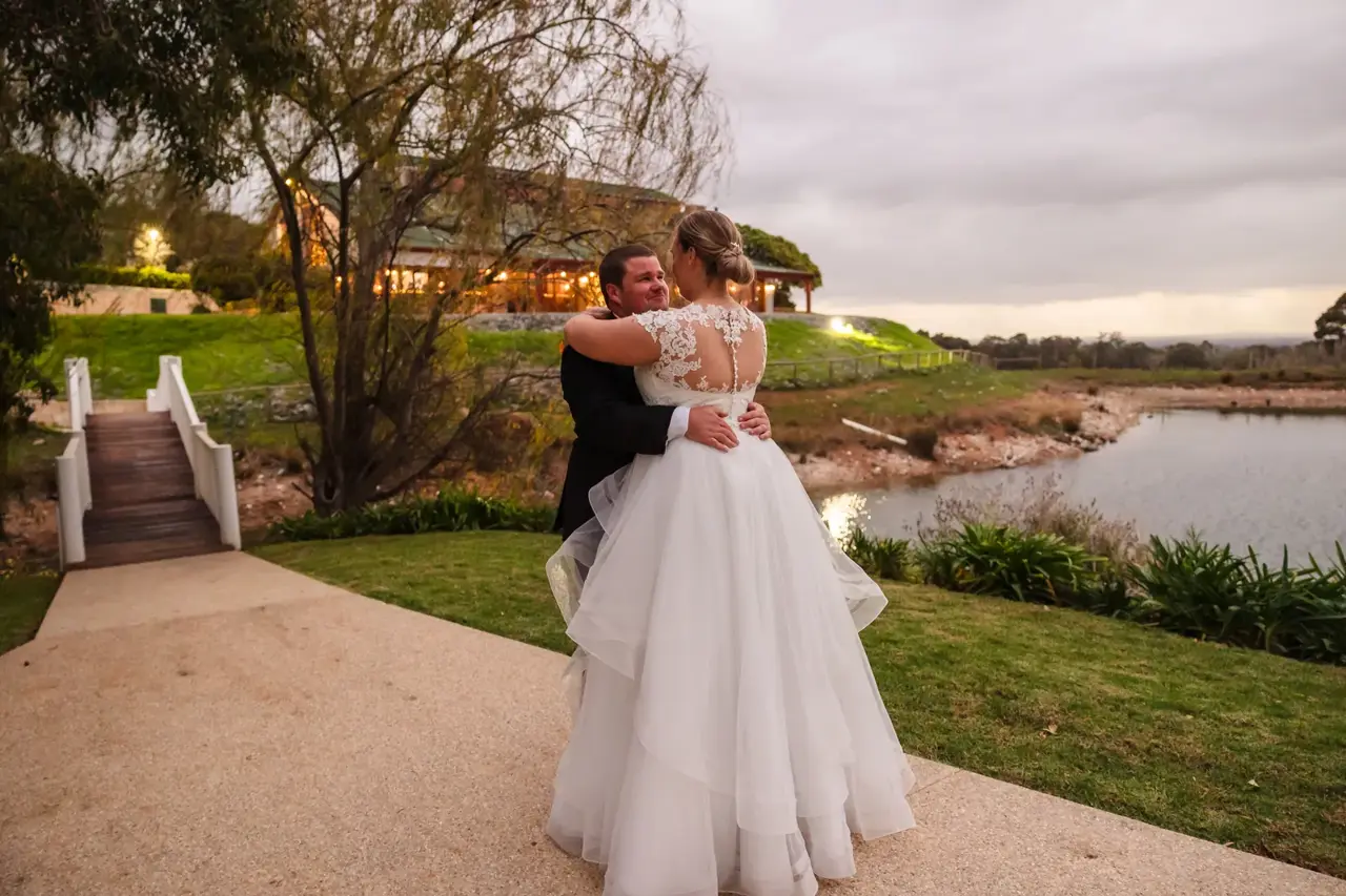 James dips Sarah for a kiss by the lake at Quarry Farm