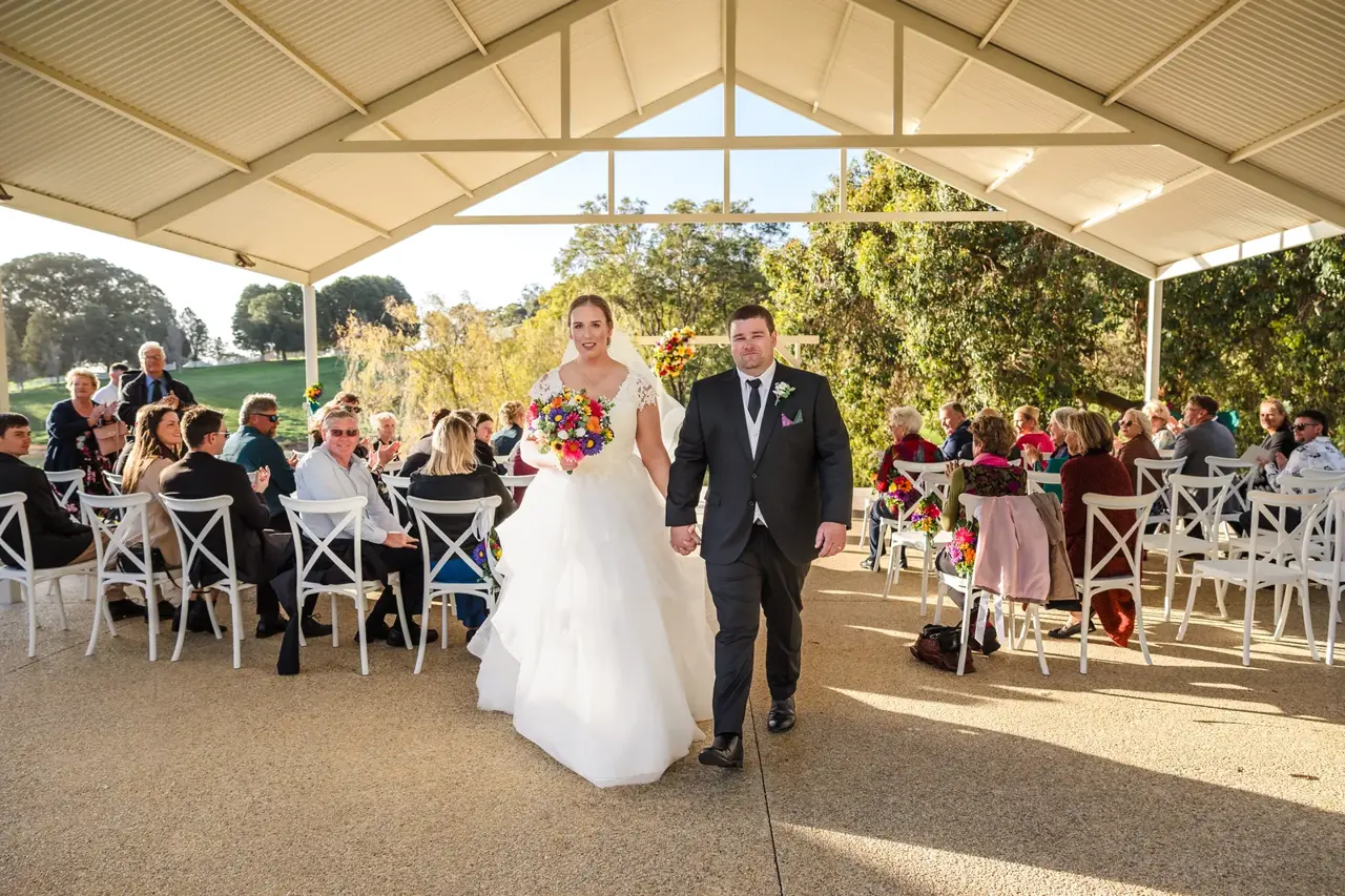 Sarah and James walk back down the aisle as newlyweds at Quarry Farm