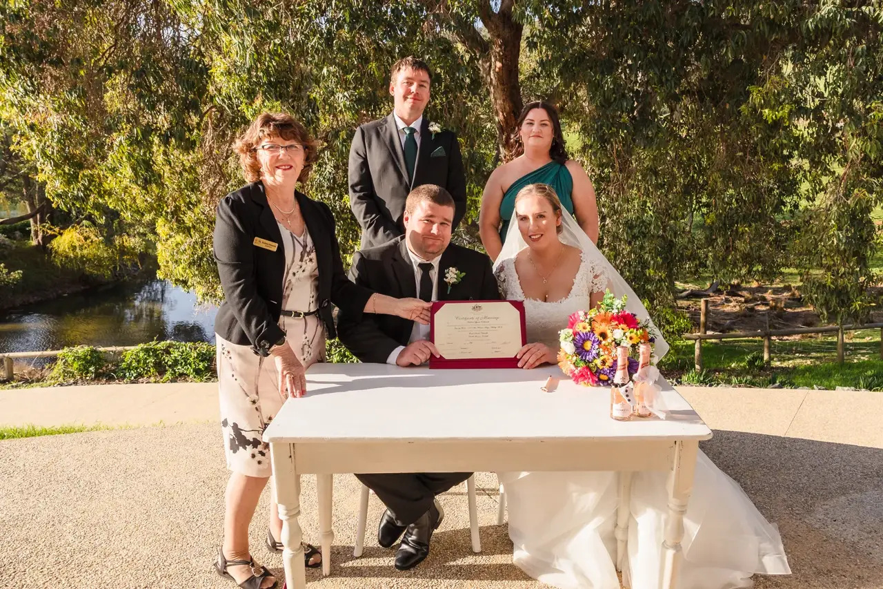 Sarah and James sign the register with their witnesses and celebrant Andrea Edwards at Quarry Farm