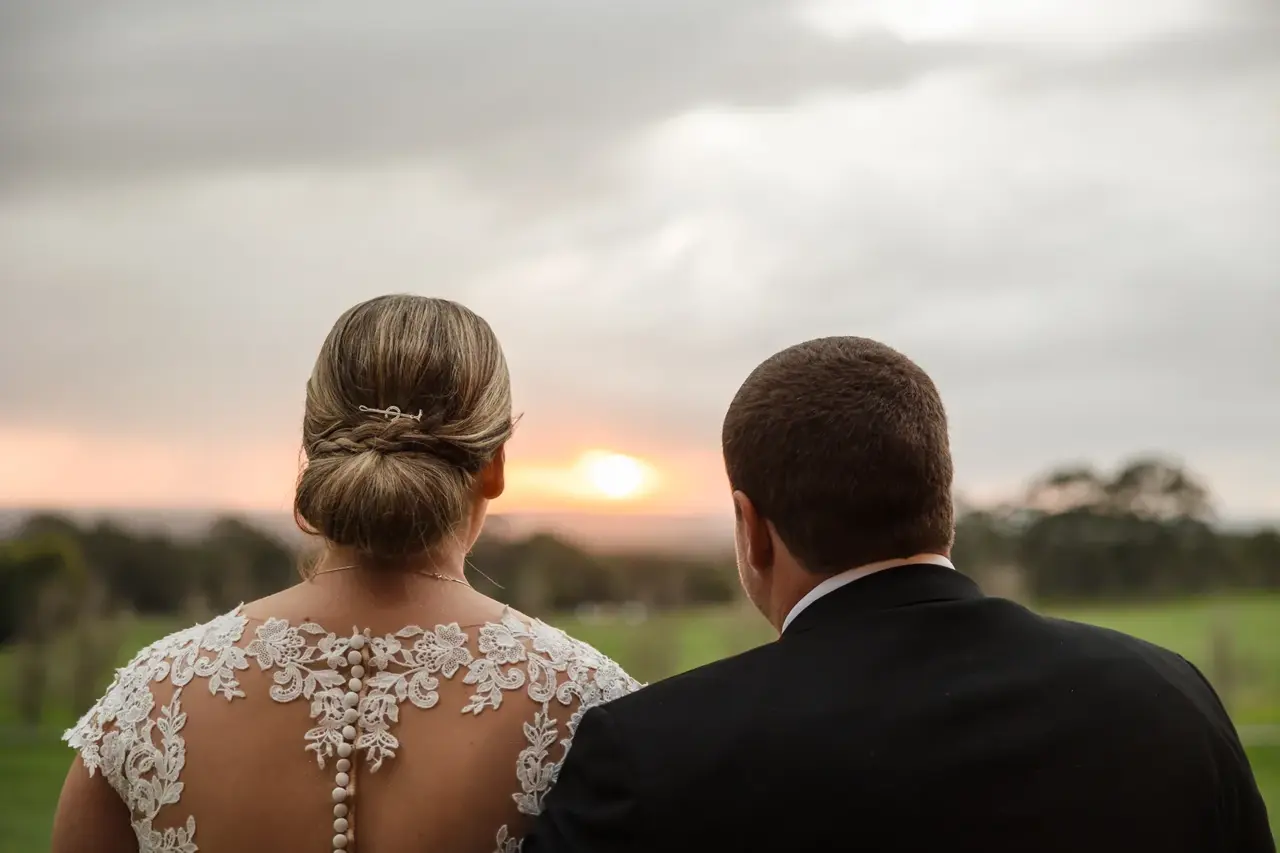 Sarah and James watch the sunset over the paddocks at Quarry Farm