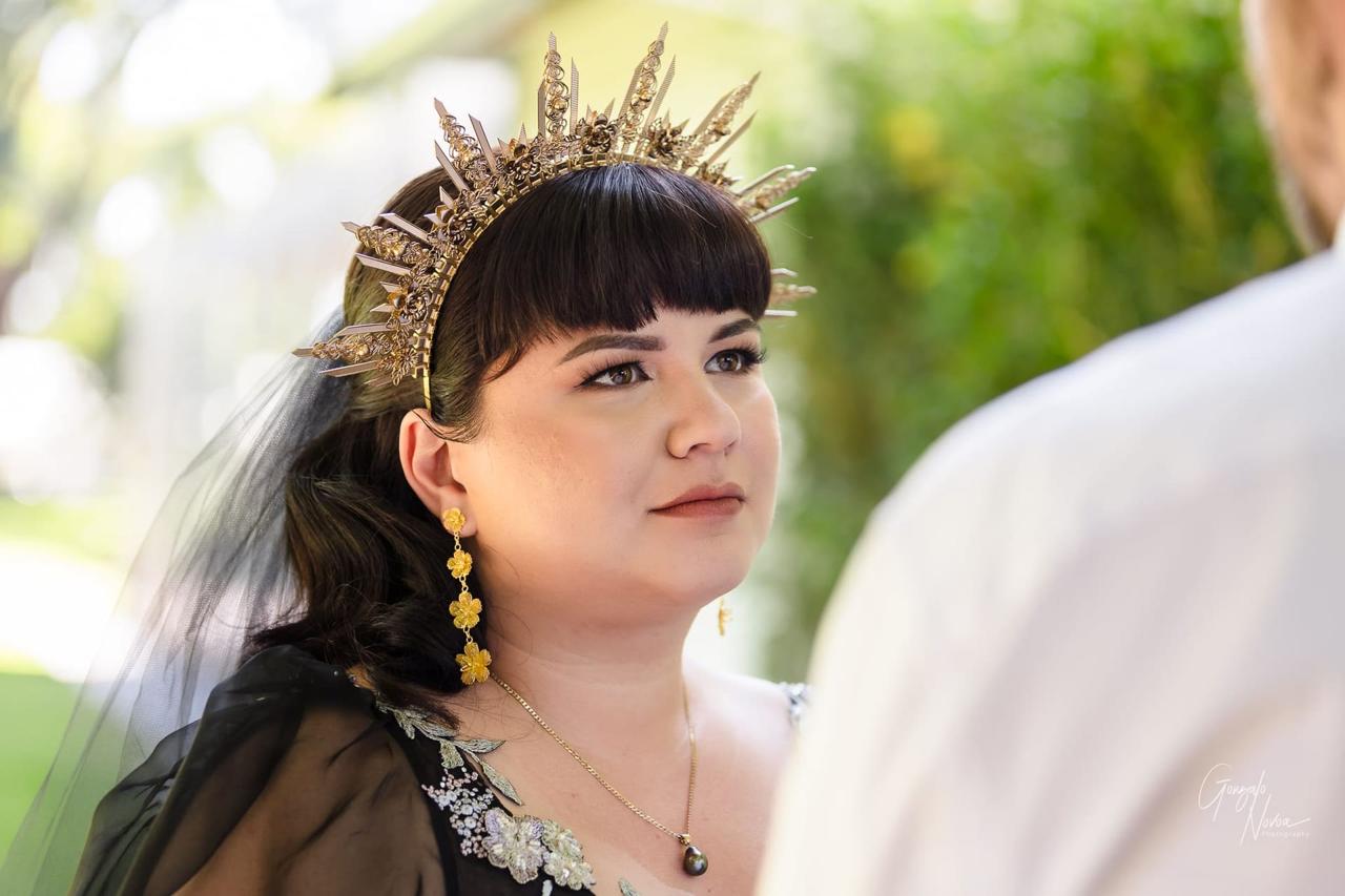 Close-up of bride with a golden crown headpiece, gazing emotionally at the groom during their First Look.