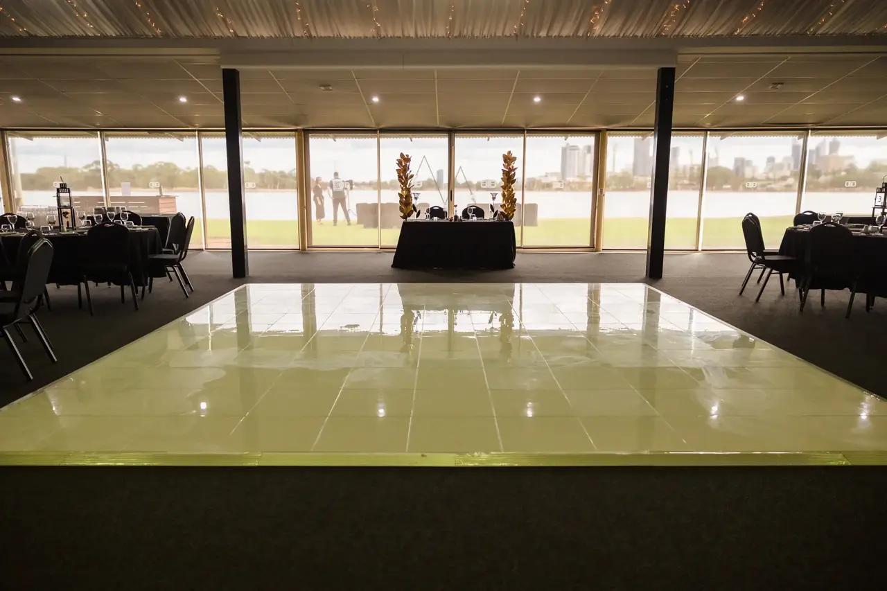 The reception dance floor with the Perth skyline through the windows at Burswood on Swan