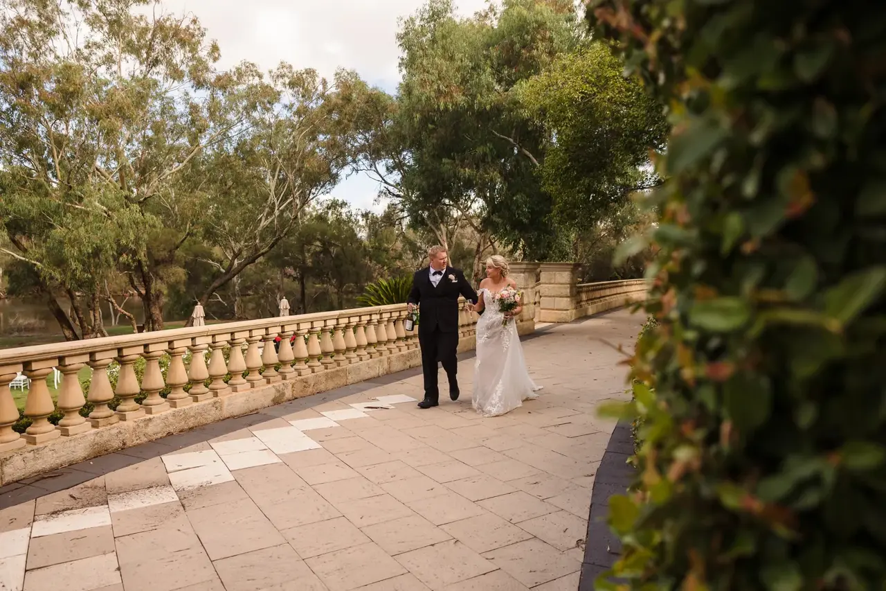 Rosie and Adam walk the balustraded path through the gardens at Caversham House