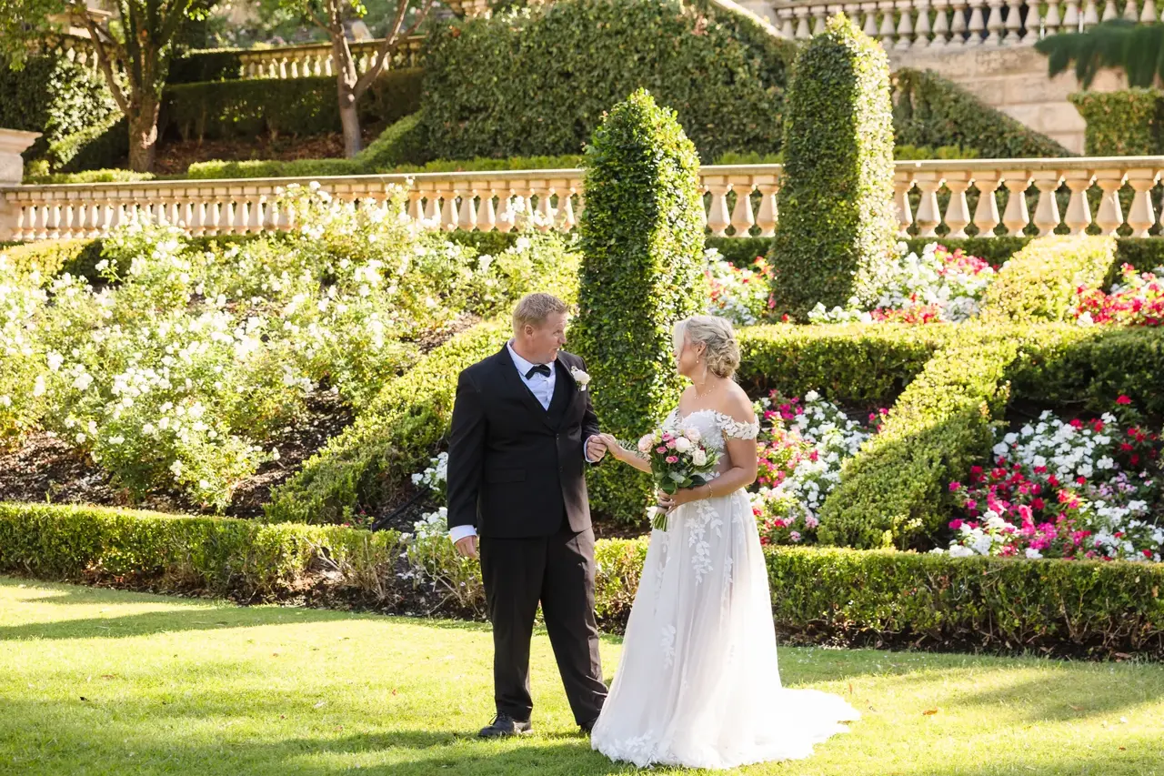 Rosie and Adam among clipped topiary and rose beds at Caversham House