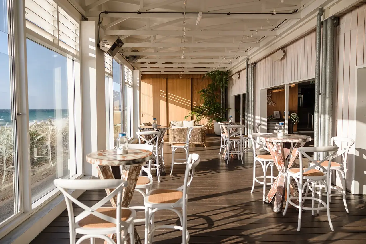 Covered deck dining with ocean views at COAST Port Beach