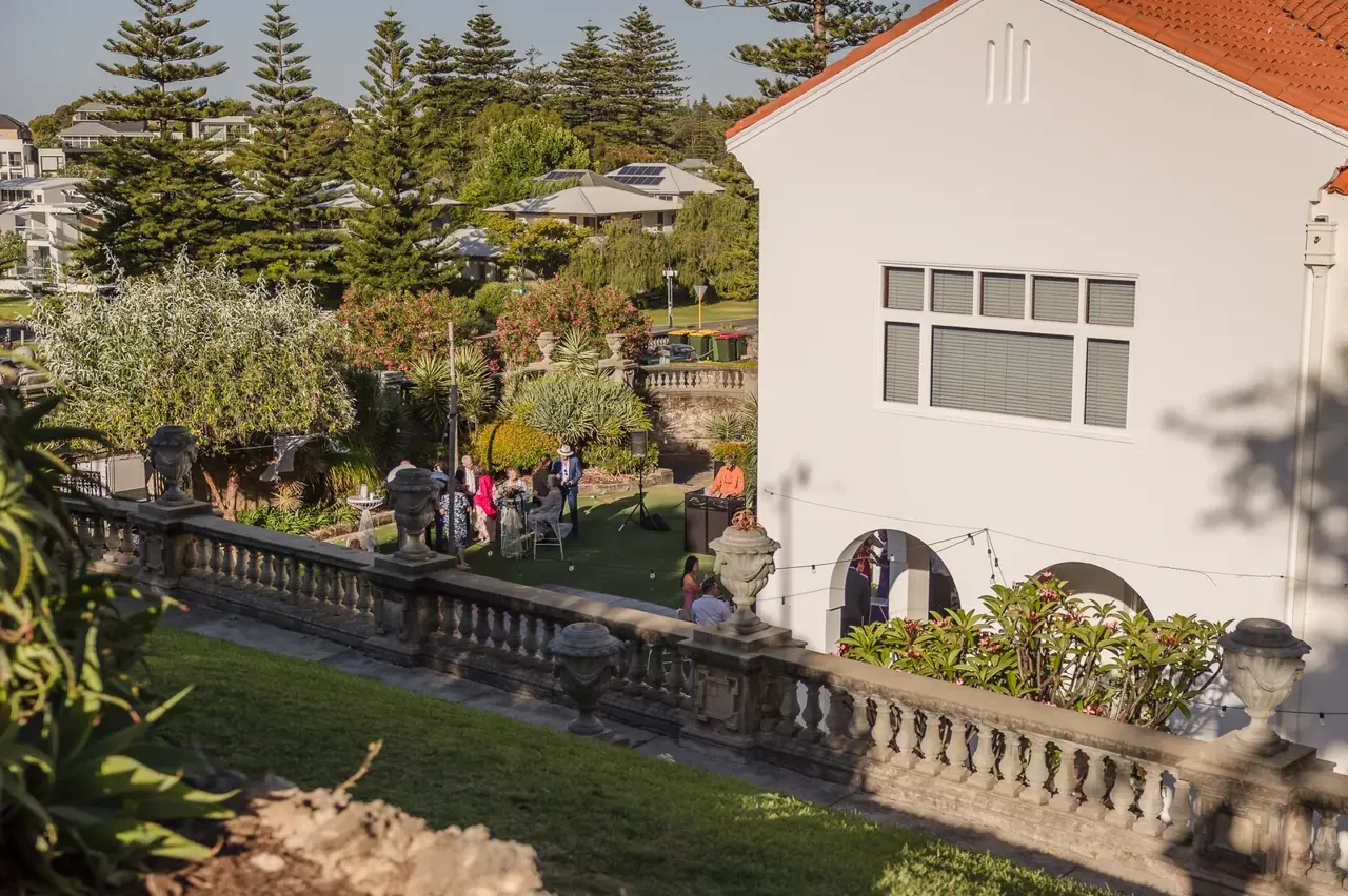 A garden ceremony in front of the Spanish Mission building at Cottesloe Civic Centre