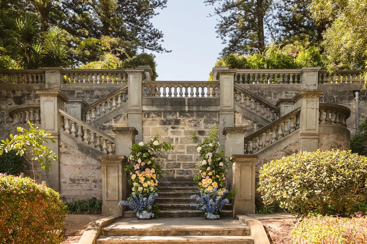 The grand limestone staircase dressed with florals at Cottesloe Civic Centre