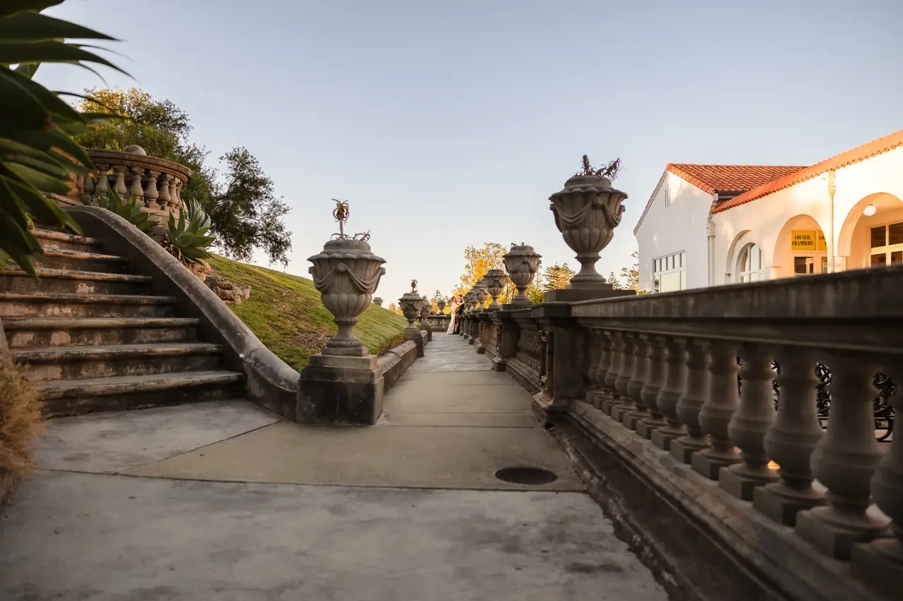 The loggia, ornate stone urns and golden garden path at Cottesloe Civic Centre