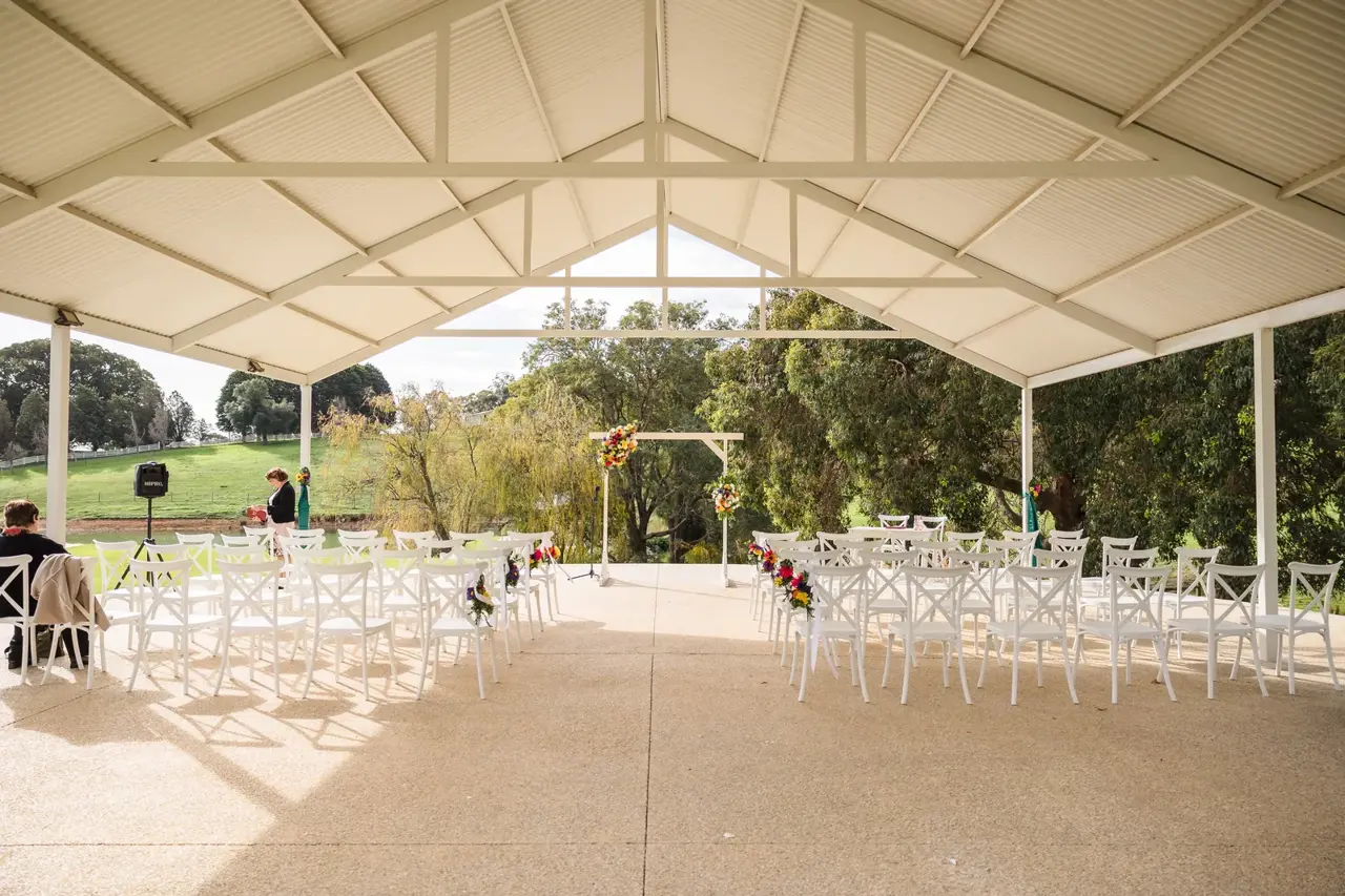 White chairs set for a ceremony under the big gazebo at Quarry Farm