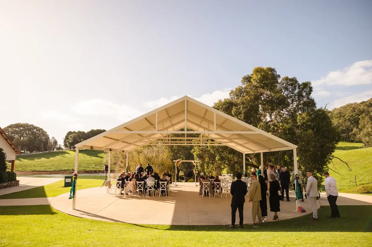 The big ceremony gazebo at Quarry Farm surrounded by green paddocks and hills