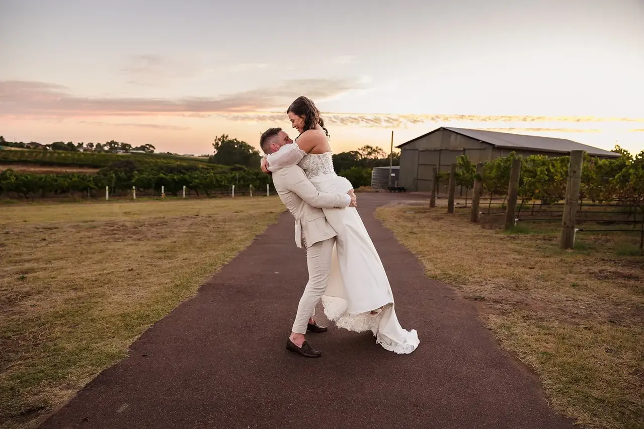 Bride and groom at golden hour on the vineyard path at Sittella Winery