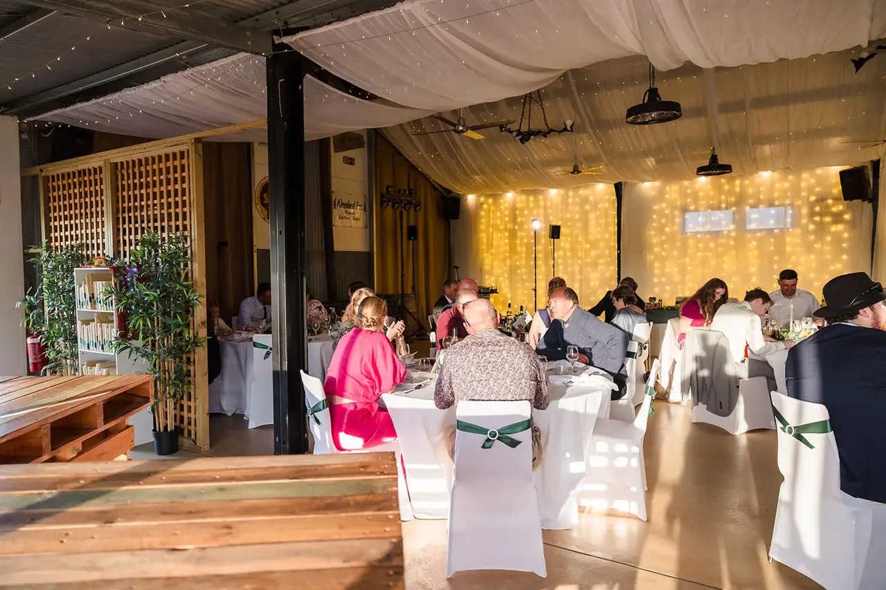 The reception room at Walkers Hill Vineyard with a draped ceiling and a wall of fairy lights