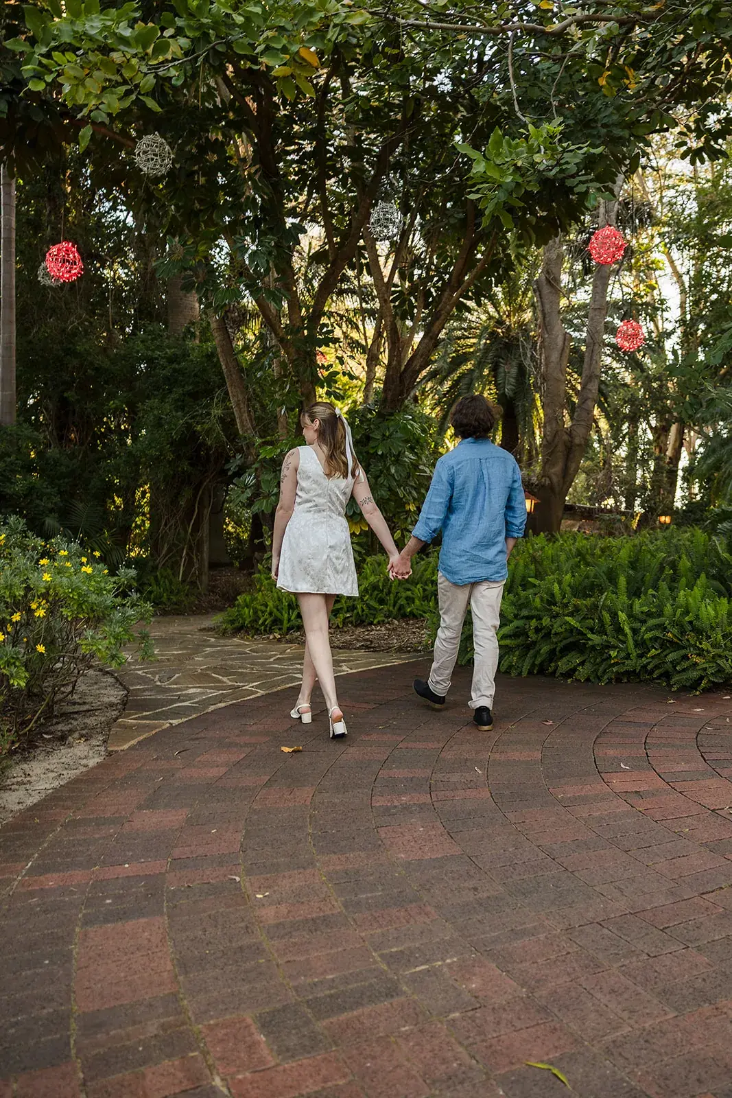 A couple walking hand in hand through the gardens at Wanneroo Botanic Gardens