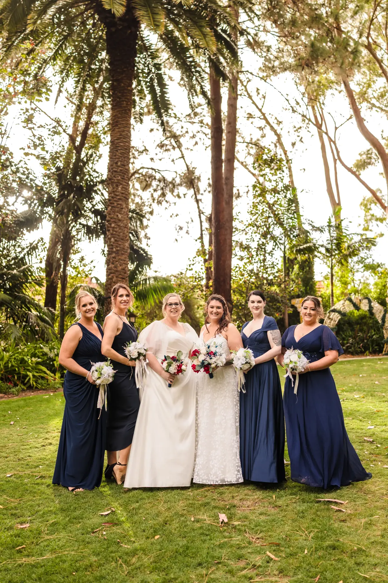 A wedding party gathered among the greenery at Wanneroo Botanic Gardens