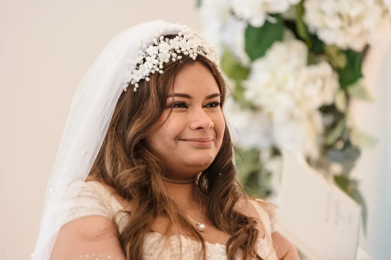 Naila in her veil listens to Kusal's vows, eyes shining