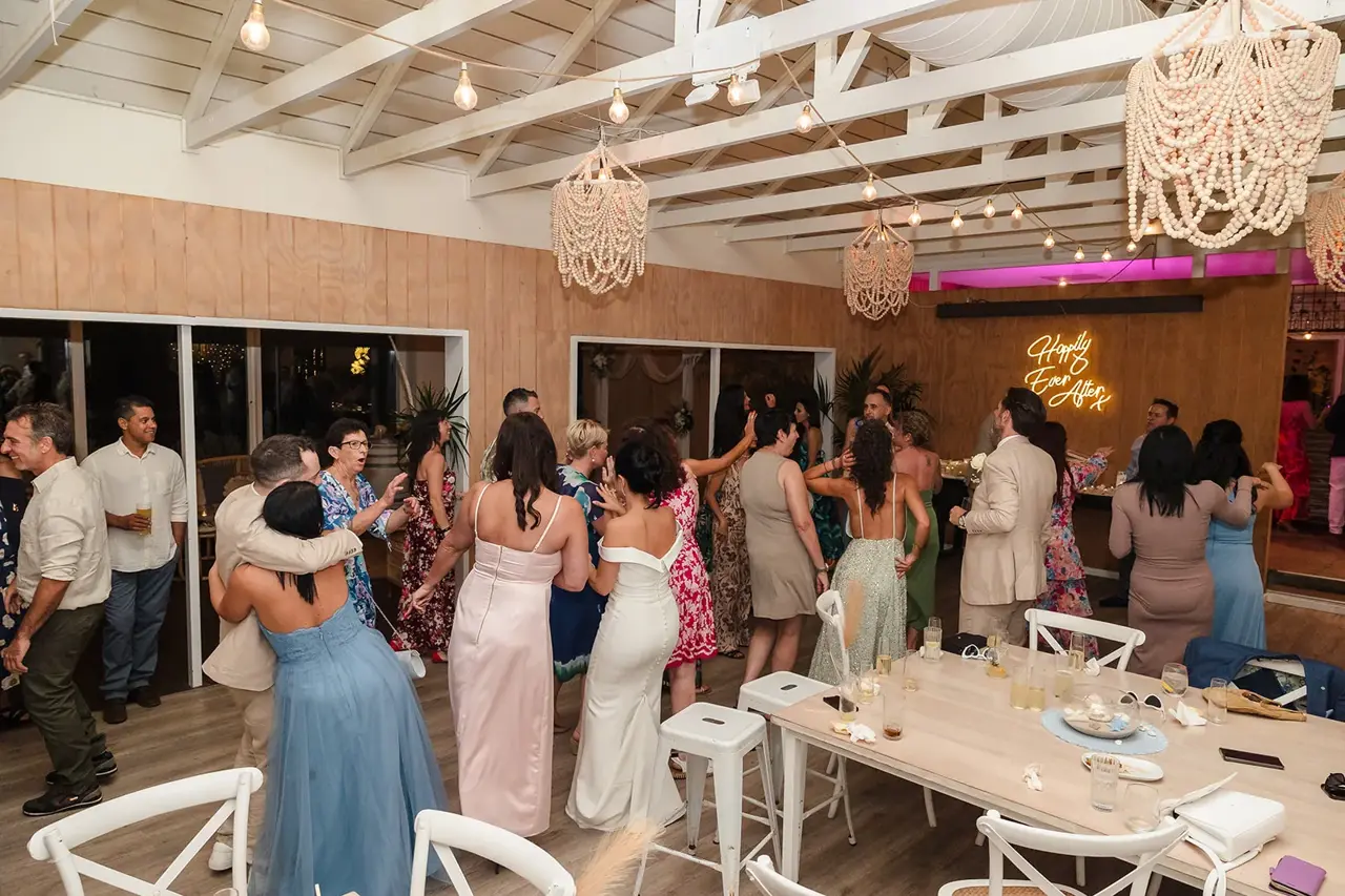 The Boathouse reception room at COAST Port Beach with white timber ceiling, macrame chandeliers and festoon lights