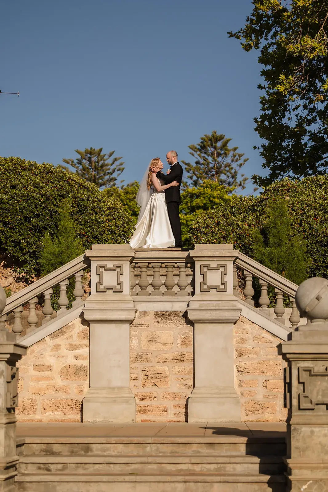Bride and groom on the staircase with ocean views at Cottesloe Civic Centre