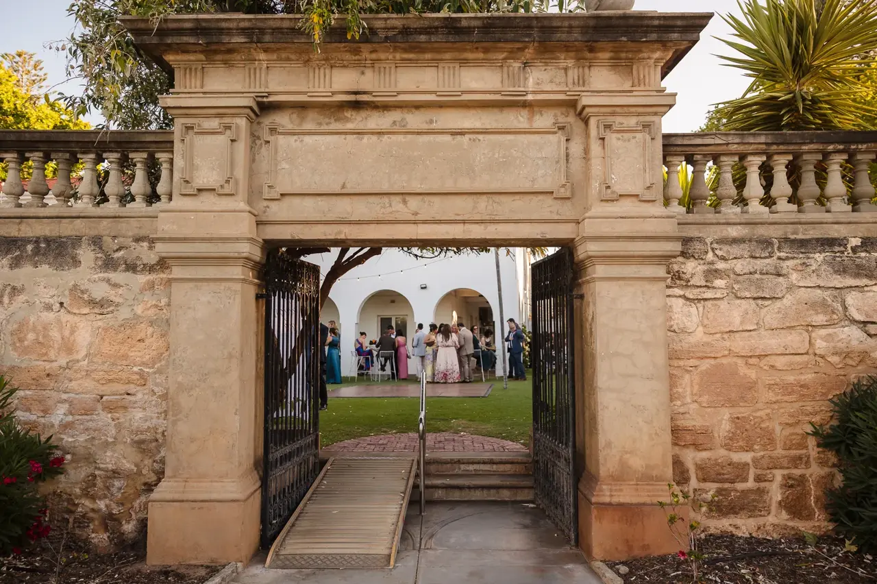 The ornate Spanish Mission stone archway framing the gardens at Cottesloe Civic Centre