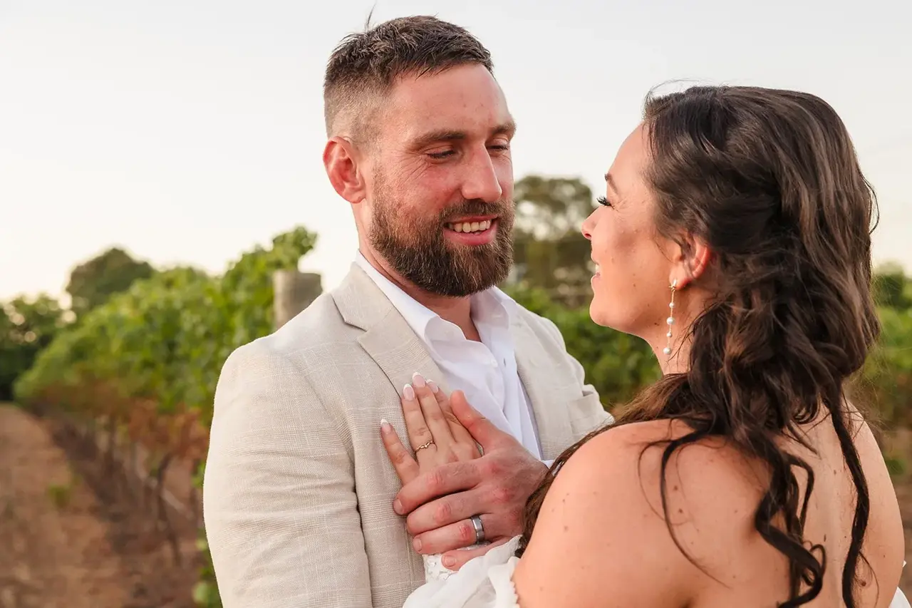 Couple embracing at golden hour in the Sittella Winery vineyard