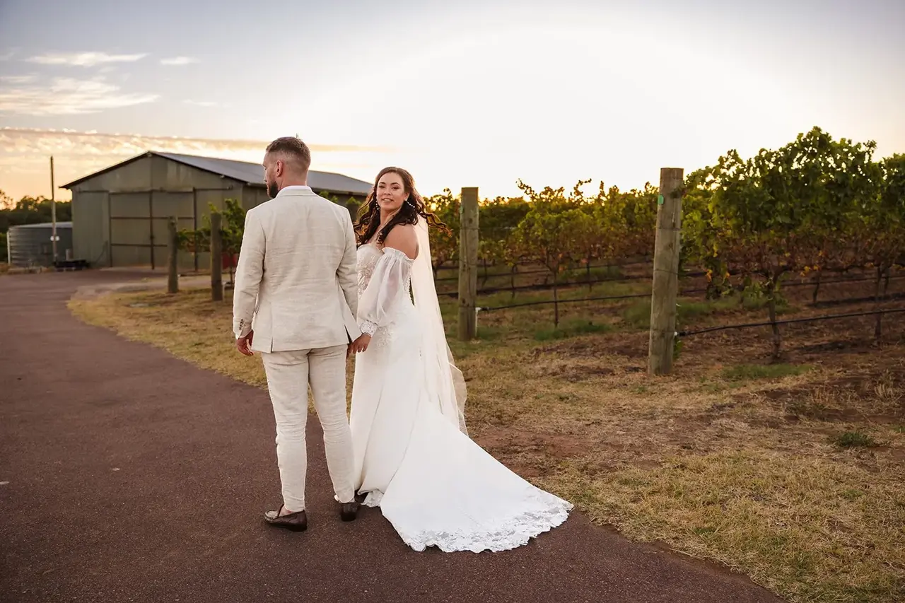 Couple walking the vineyard path at sunset, Sittella Winery wedding