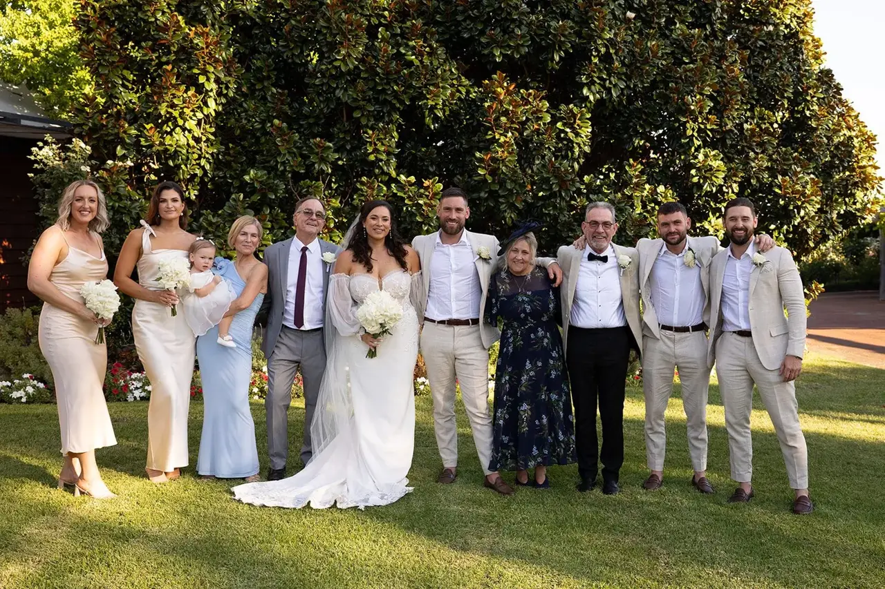 Wedding party on the lawn in front of the vineyard at Sittella Winery