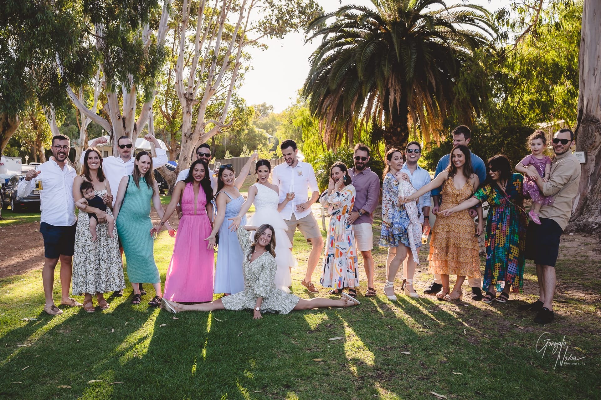 Bride and groom with wedding guests guests posing for the shot