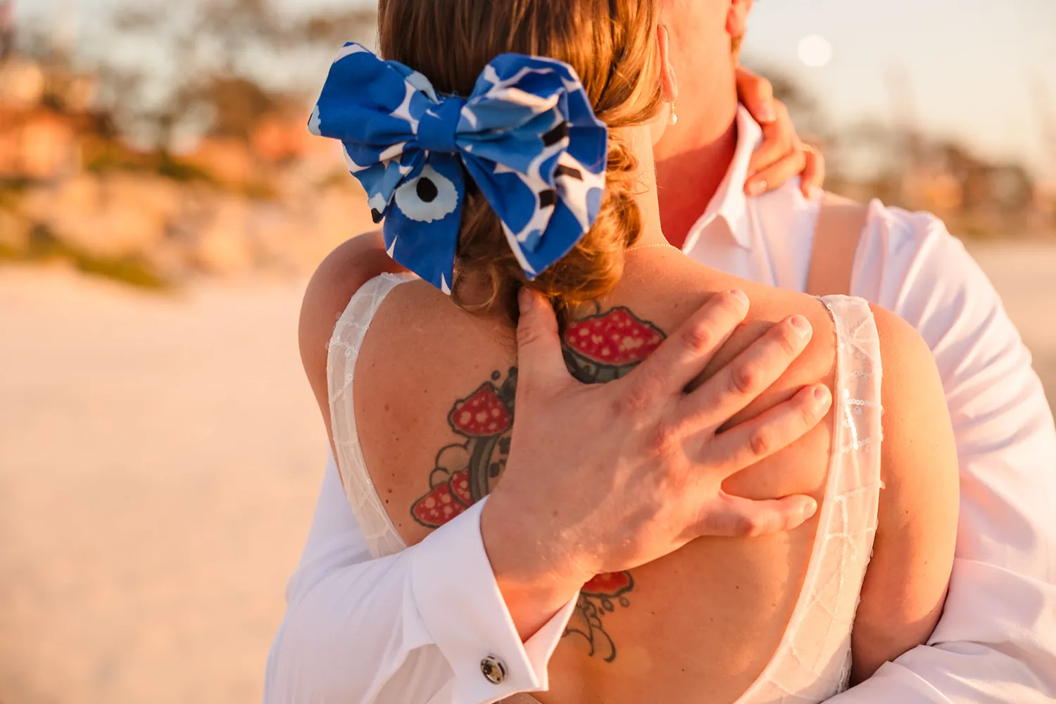 Detail of the blue Marimekko hairpiece and wedding ring on the beach