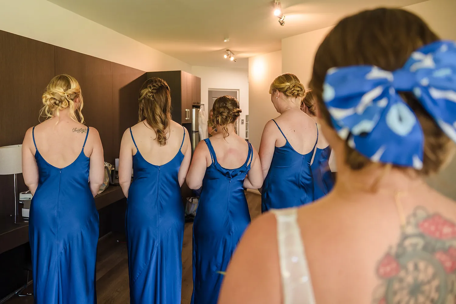 Bridesmaids in navy dresses holding white bouquets
