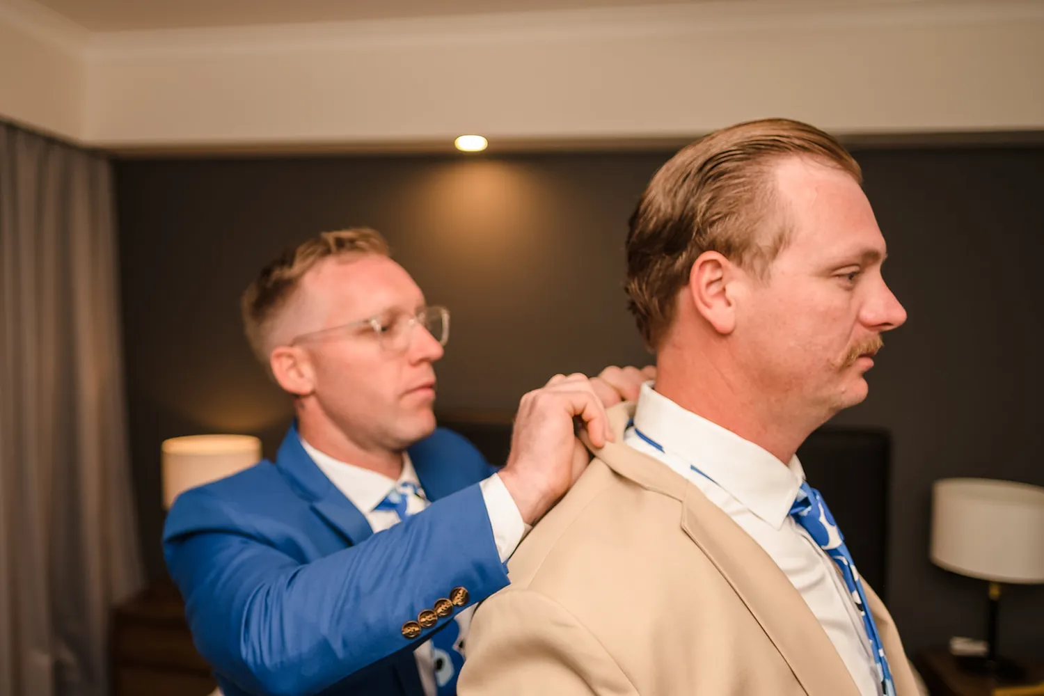 Groom Andy getting ready in his blue suit