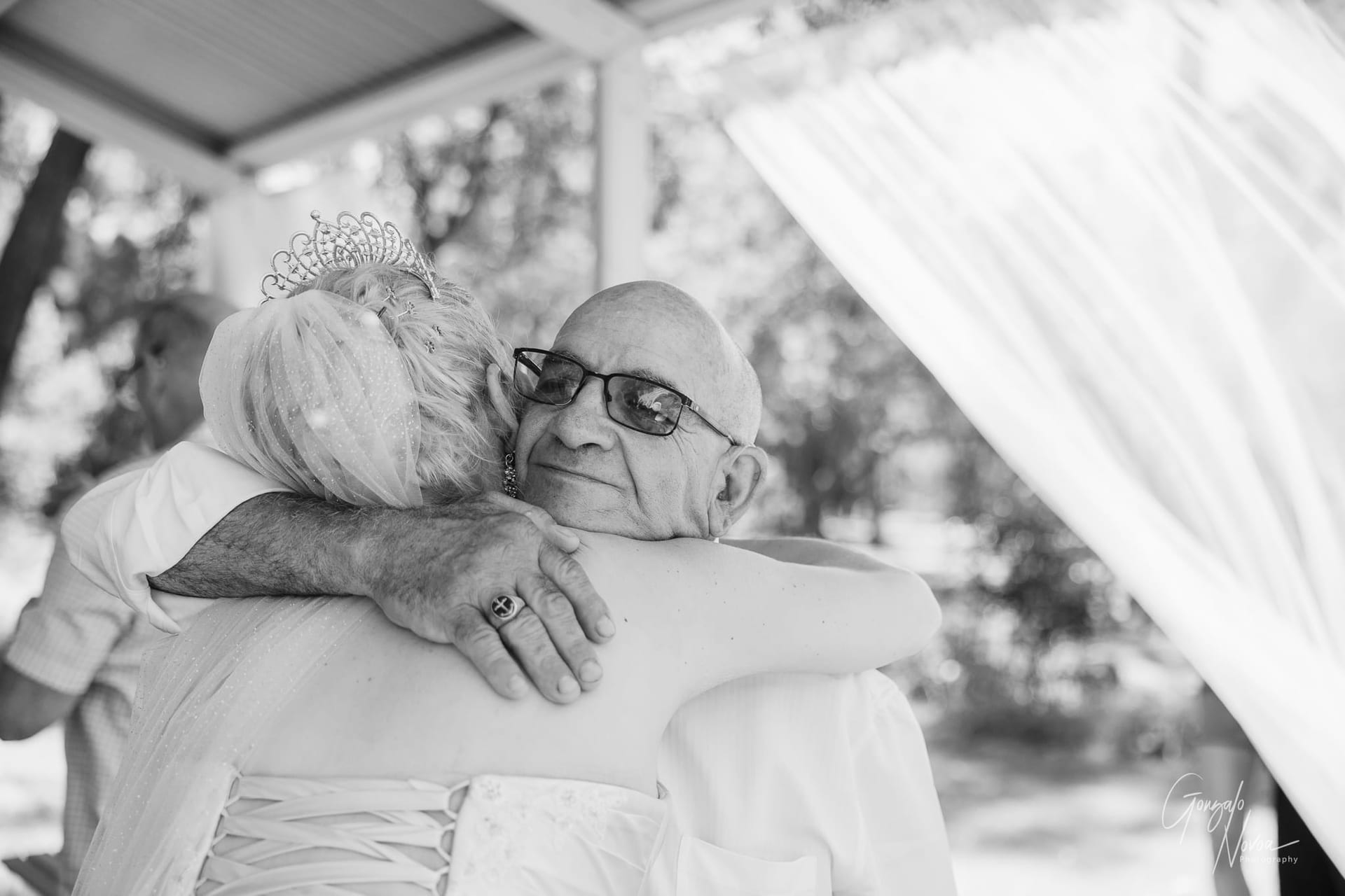 An emotional moment as the bride hugs a loved one, capturing the deep connection between them.
