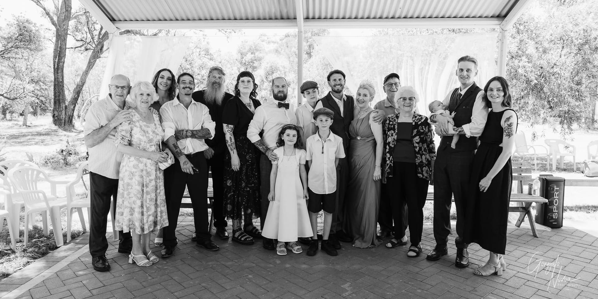 A heartwarming group shot of wedding guests standing together to celebrate the couple’s special day.