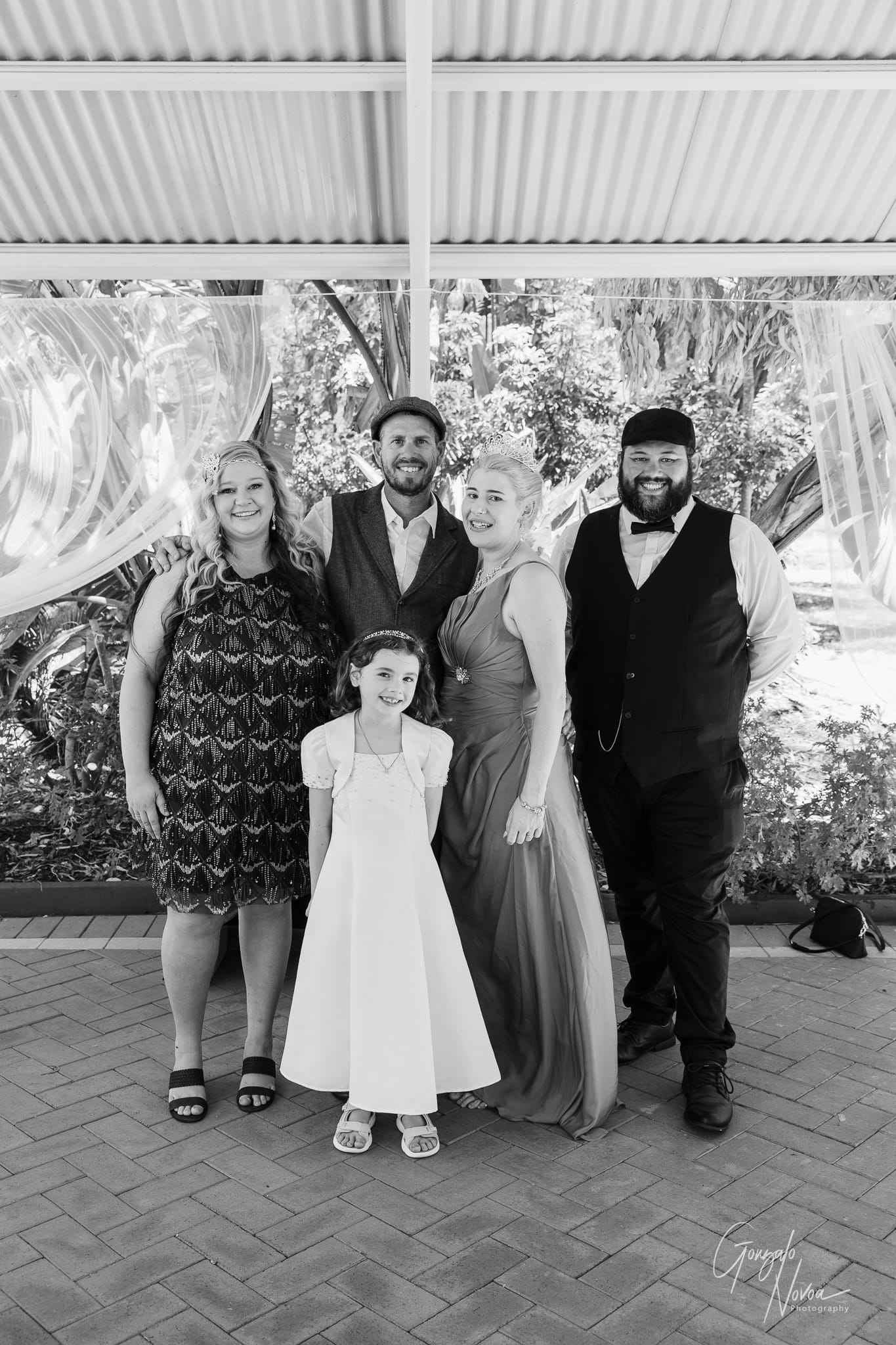 A joyful group photo capturing family and friends on the wedding day.