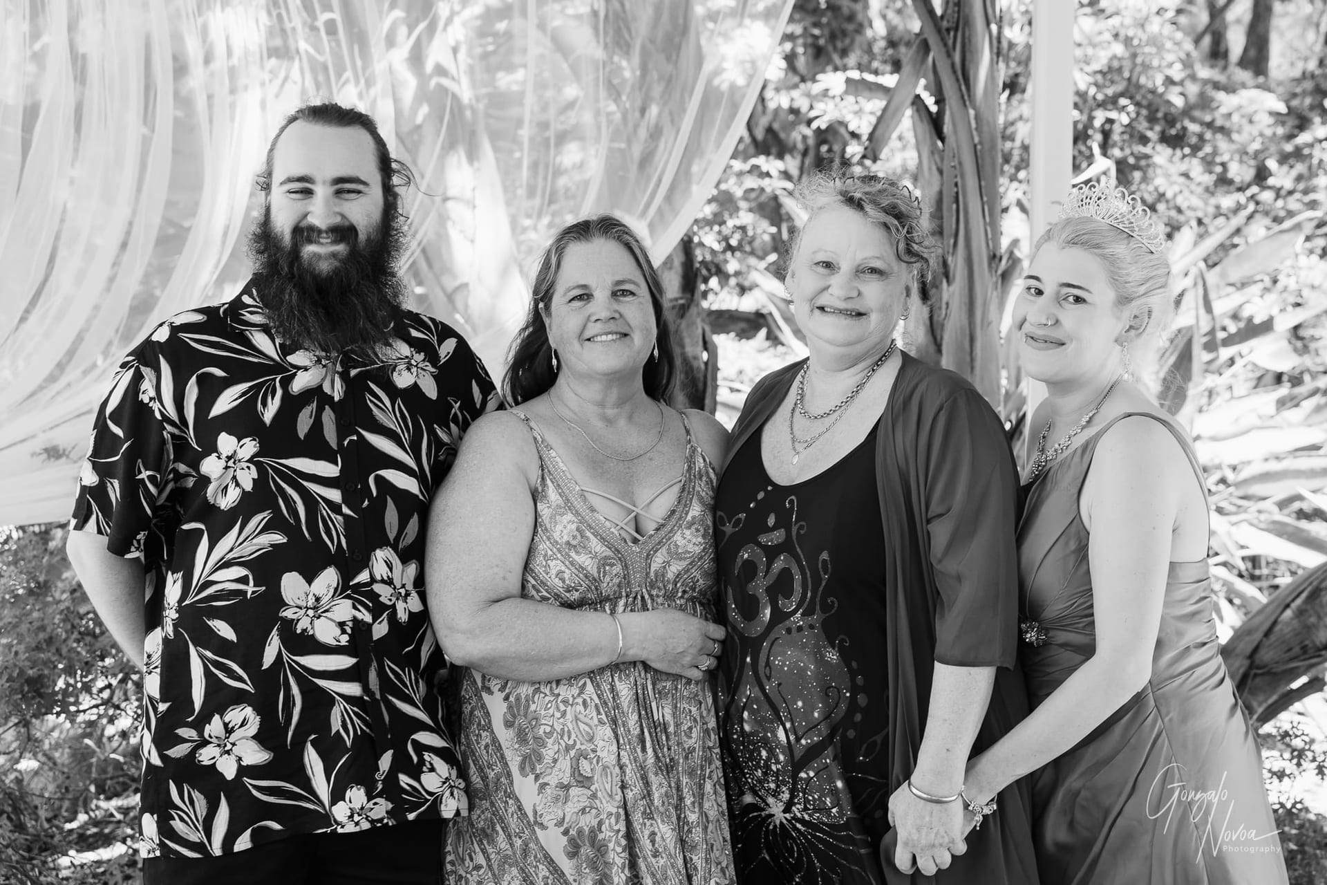 A joyful group photo capturing family and friends on the wedding day.