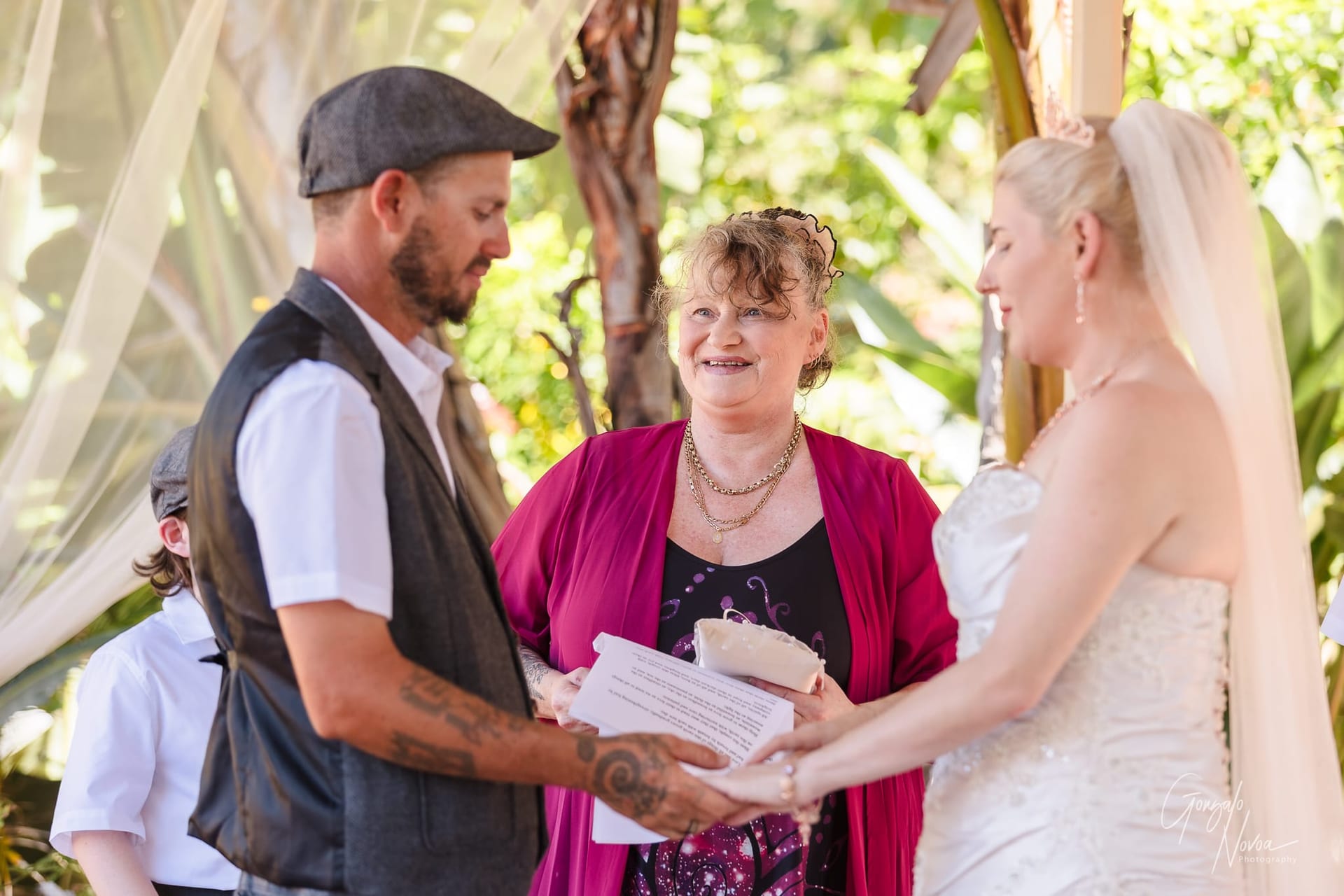 Karissa  and Josh holding hands during the ceremony