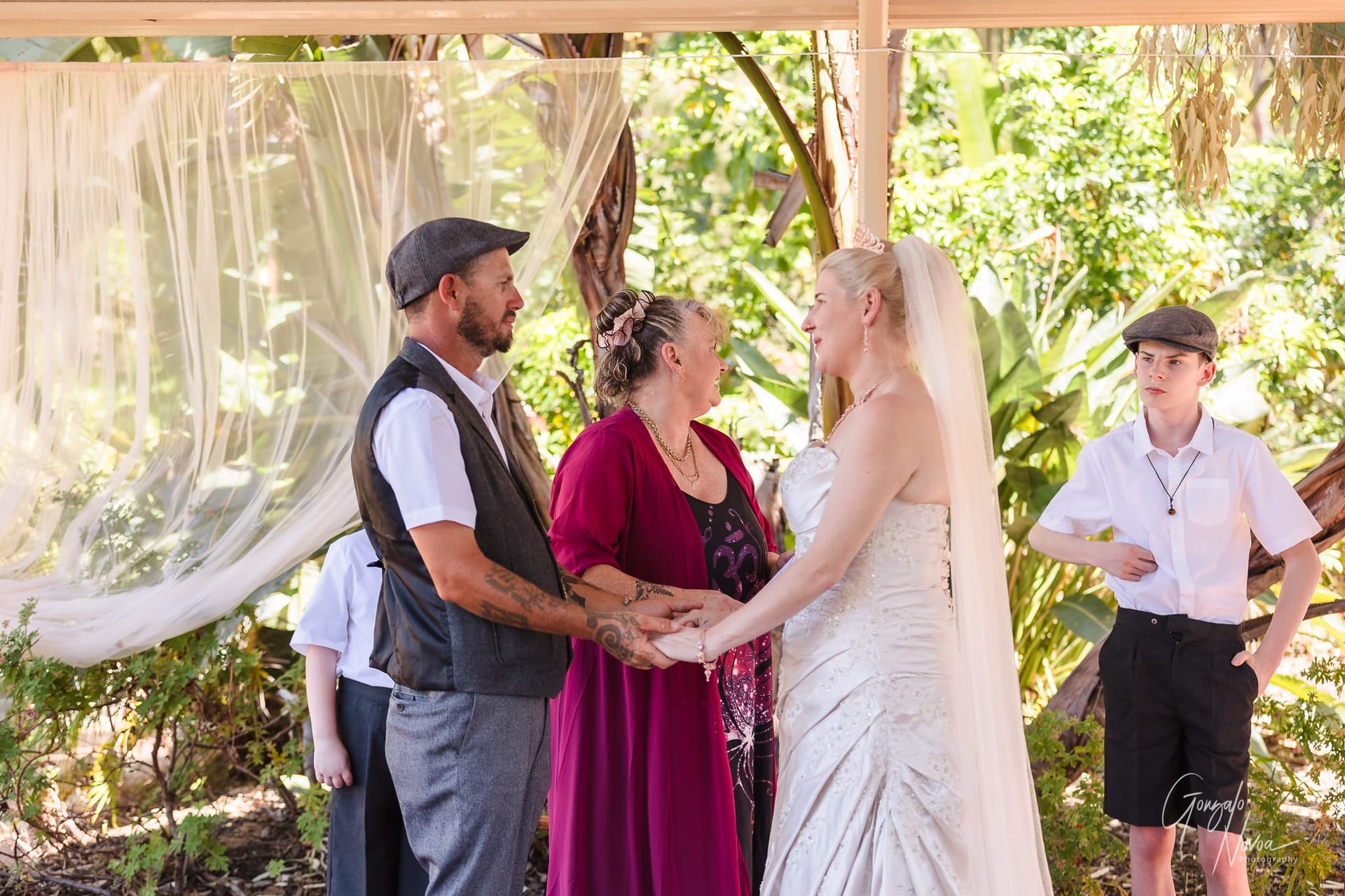 Karissa  and Josh holding hands during the ceremony