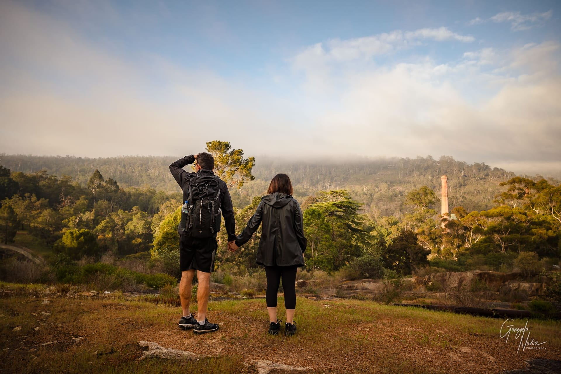 Sunrise fog in the distance. Maria and Fabio observing the land