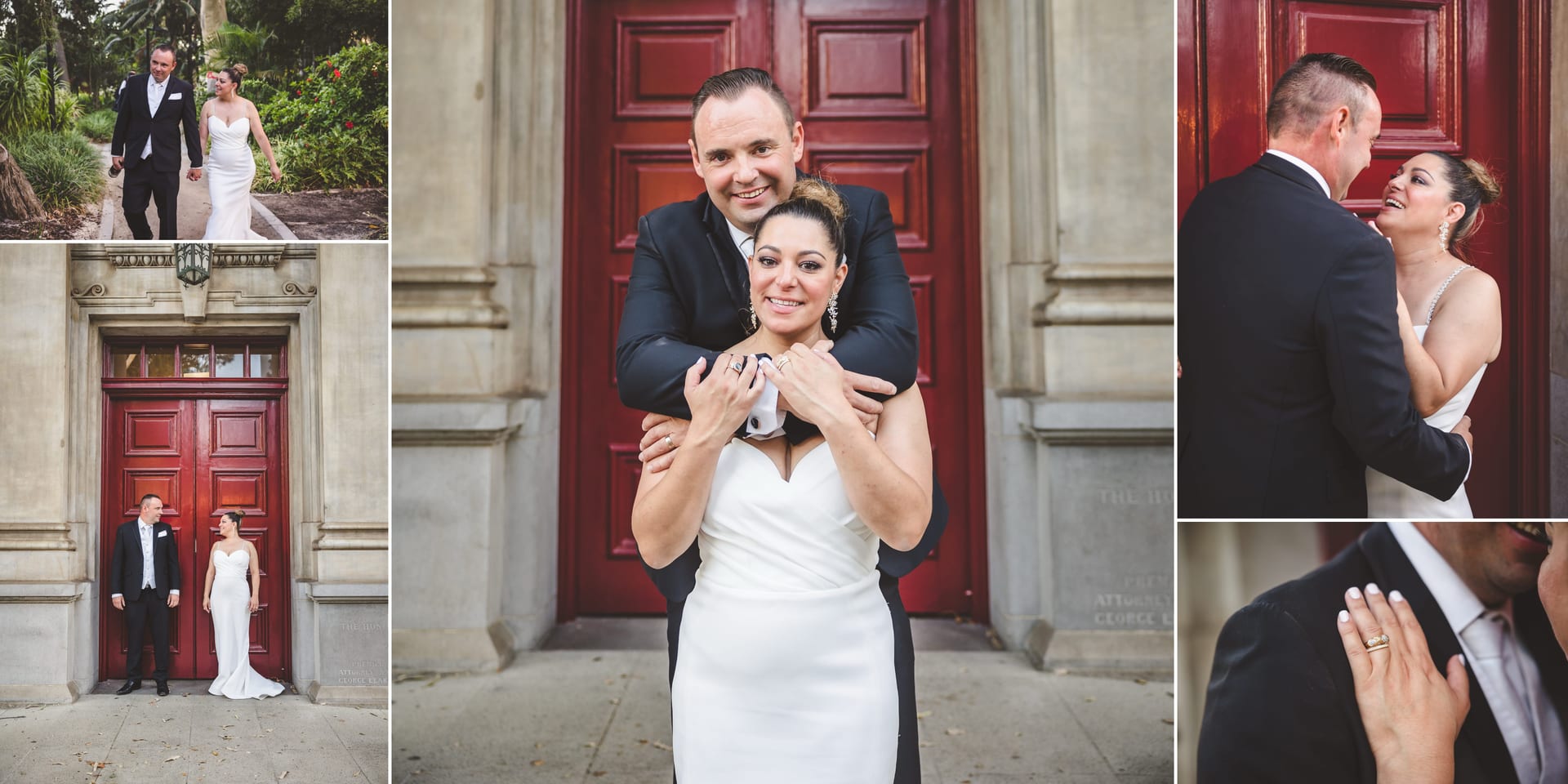Bride and groom in wedding attire, smiling and embracing, with a red door and greenery in the background. Joyful and romantic mood.