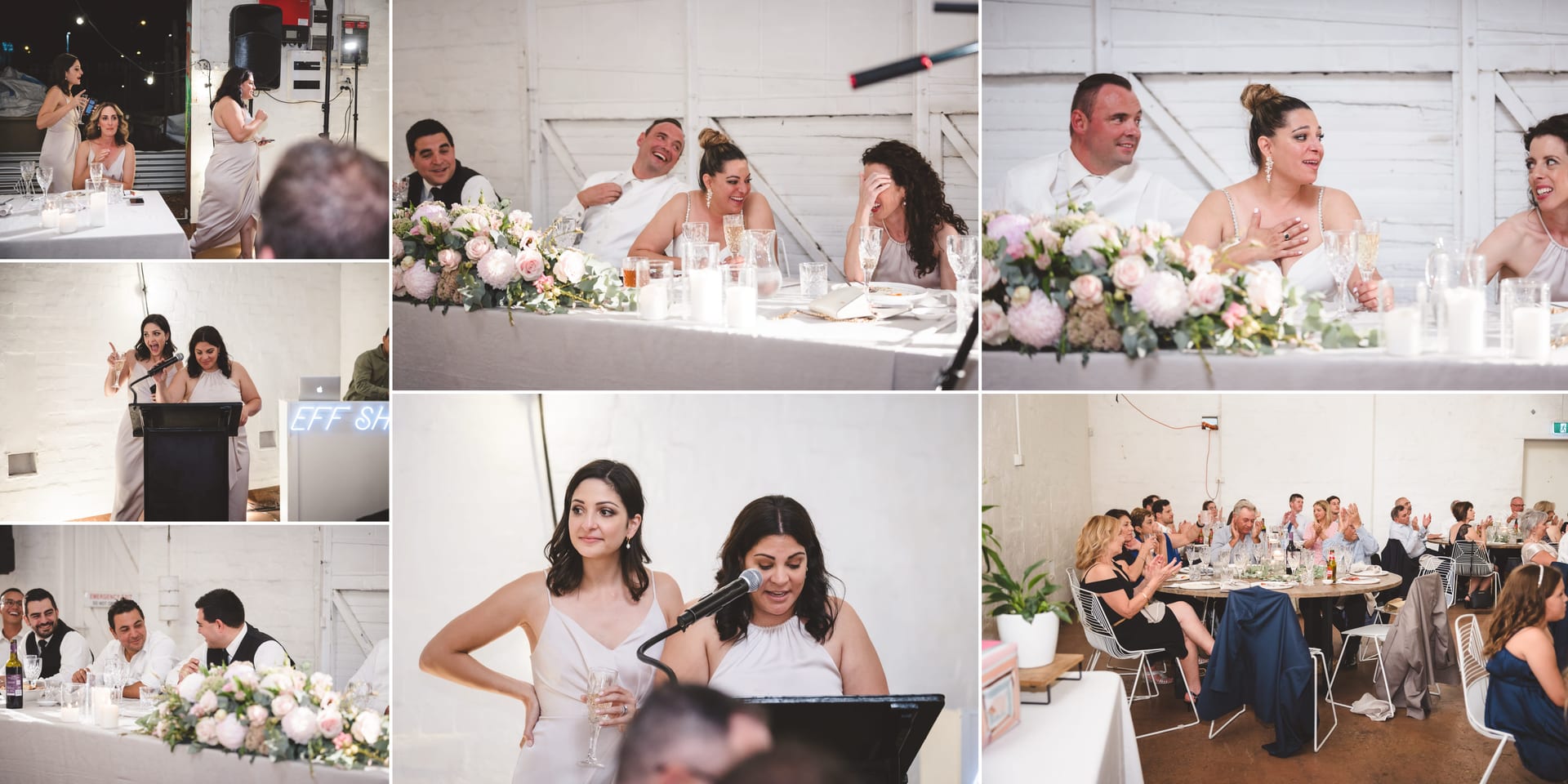 Guests in a bright room enjoying a wedding reception. Two women give a speech at a podium. Floral arrangements and candles decorate tables.