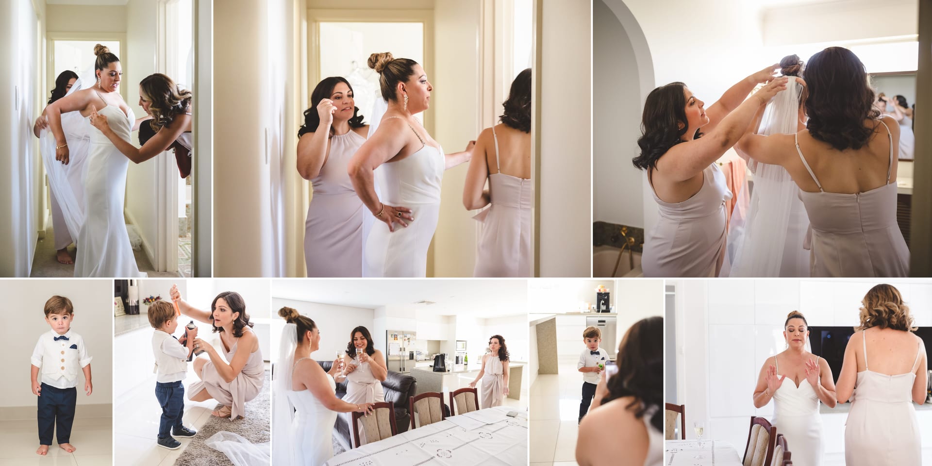Women in white dresses help a bride get ready in a bright room. A young boy in formal attire stands nearby. The mood is joyful and busy.
