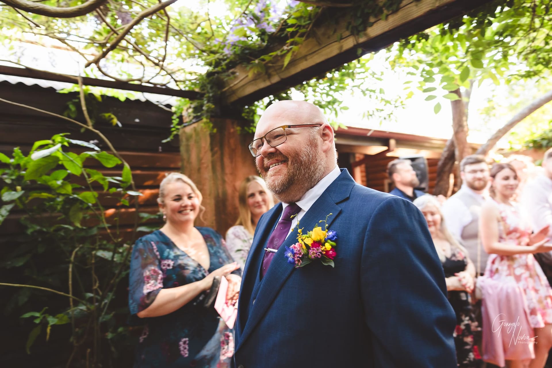 Big smiles! The groom makes his way to the altar